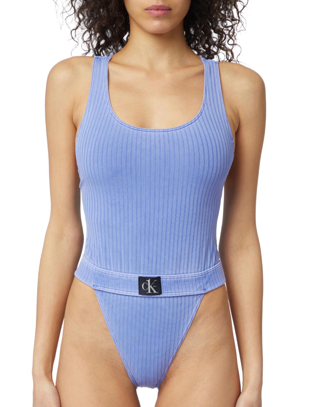 Add a touch of athleisure chic to your suitcase this season with this luxurious swimsuit from the timeless CK One Authentic collection by Calvin Klein. The classic shape features a racerback design that creates a trendy sports-luxe style. The high-cut legs elongate the legs and the belt-like design cinches the waist with an added CK One logo for a designer detail. Moulded cups create a smooth finish and the pull-on design allows for easy wear.  Trendy sports-luxe style Sporty racerback CK One logo High cut leg Moulded cups Non-wired Pull-on design Country of origin: Sri Lanka Composition: 91% Polyamide &pipe; 9% Elastane Listed in UK sizes  56192-99784-1298764 KW0KW01639 Swimsuit