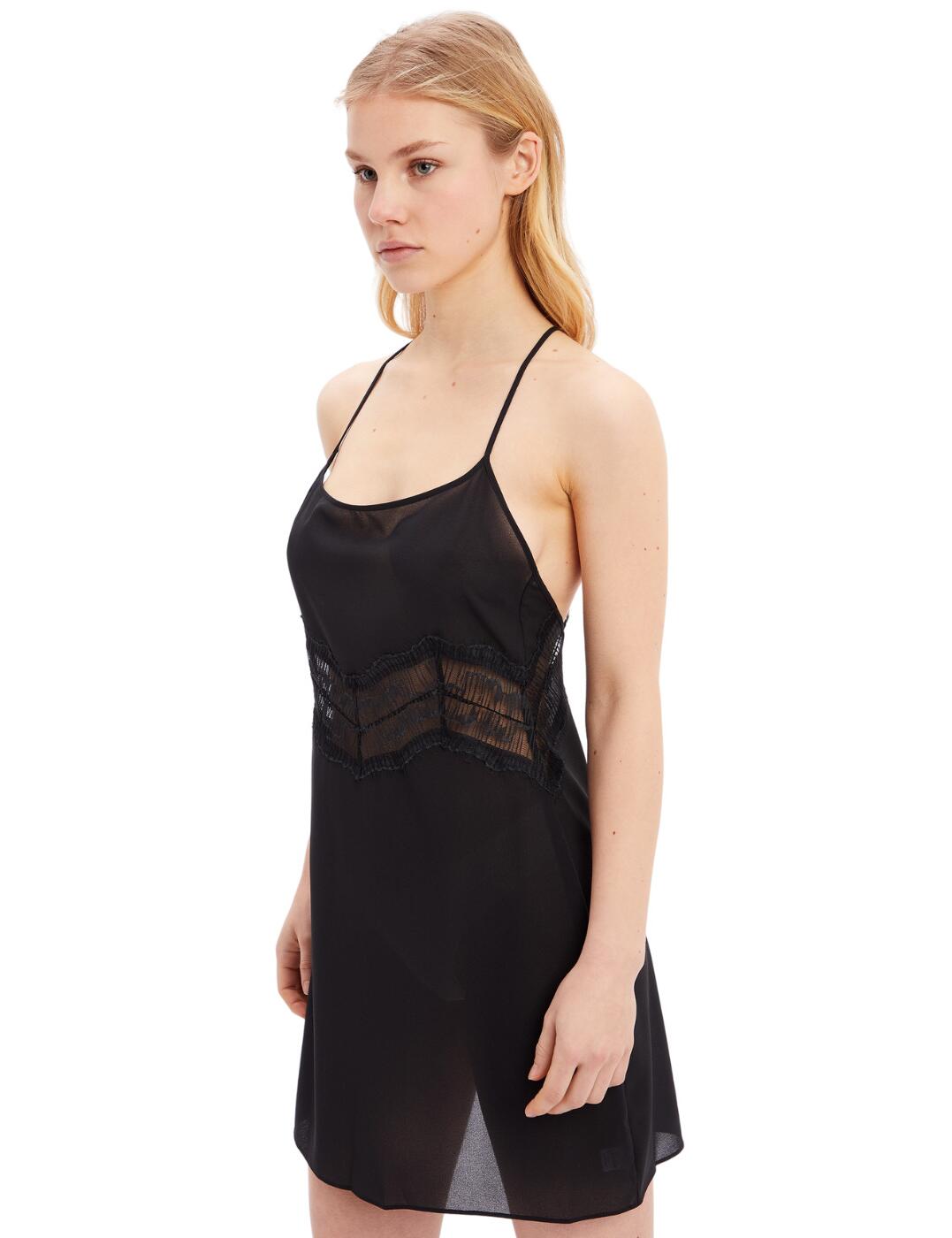 This Calvin Klein CK Black chemise is seductive and sensual. The sleek design slips on and has adjustable shoulder straps to keep it secure and comfortable. The straps cross at the back and lead to a low cut, making this night dress enticing and alluring. Falling to a mini length, this piece is guaranteed to add a flirtatious flair to your lingerie collection. Show off your body with a cut that wraps your curves and the sheer lace panel in the midsection gives a glimpse of the beauty underneath.  Lightweight and comfortable Sheer lace panel Mini-length Adjustable shoulder straps Cross back design Low-cut back Country of origin: China Composition: 100% Polyester Listed in UK sizes  57162-101141-1310736 000QS6846E  Chemise