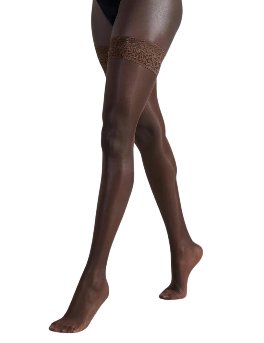 Indulge in your sensual side with Bluebella's lace top hold ups. An elevated classic, these lace top hold ups are the dream addition to your lingerie drawer. Featuring a gorgeous wide lace band that adds an opulent flair whilst the sheer matte finish smooths and enhances your legs. These hold ups are designed to be silky smooth against your skin and boast a flawless look with each wear.  Classic matte finish Flawless and elegant Deeply feminine wide lace band Ribbed silicone bands ensure these hold ups are secure 15 denier sheer matte finish Country of origin: Italy Composition: 85% Polyamide &pipe; 15% Elastane Listed in UK sizes  41453-BY-S 41453  Lace Top Hold Ups