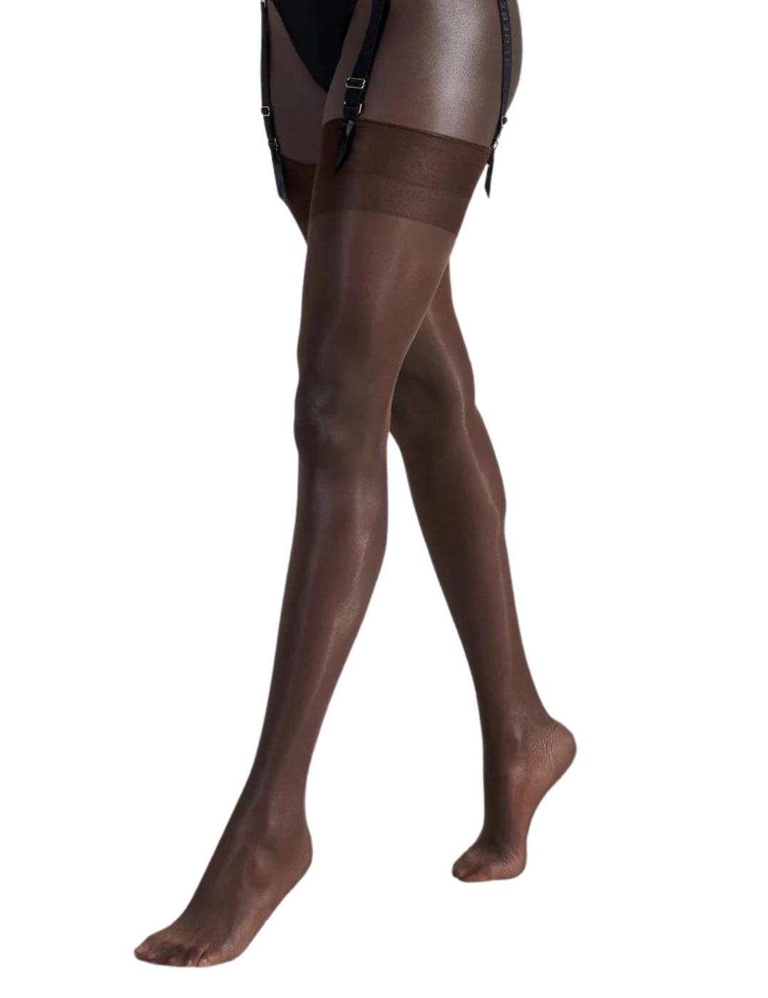Feel your most luxurious with Bluebella's plain top stockings. These glamourous stockings boast a simplistic wide top that gives these stockings a modern contemporary feel. Ultra-lightweight and soft, these stockings come with a 10 denier finish for an effortlessly flawless sheer matte look. Designed to elevate any outfit these plain top stockings are the perfect addition to your lingerie drawer.  10 denier with a sheer matte finish Wide minimalist top band for an elegant touch Soft against the skin Feminine and so daring Country of origin: Italy Composition: 85% Polyamide &pipe; 15% Elastane Listed in UK sizes  41462-BY-S 41462  Plain Top Stockings
