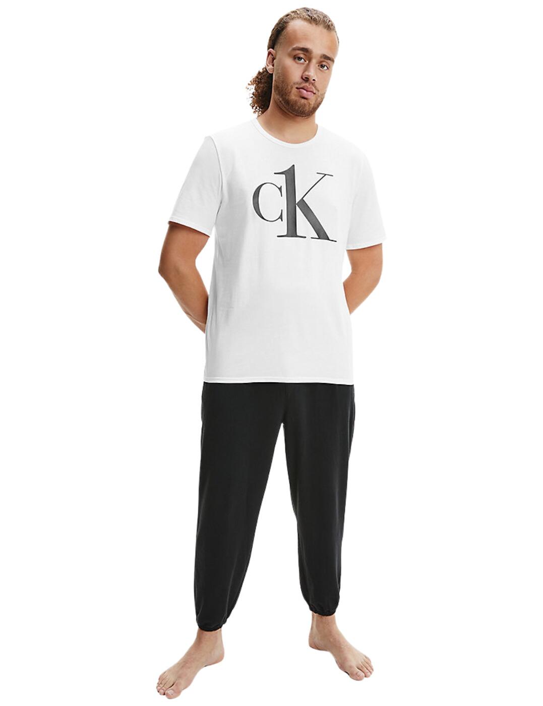 This comfy t-shirt is the perfect pullover loungewear. This timeless CK One top is perfect all year round, throw it on in summer with your pyjama shorts or layer it up in the colder months. This Calvin Klein t-shirt is made from the utmost soft fabric making this the ideal t-shirt for all-day wear with a classic crew neckline. The CK One logo is printed big and bold for an unmistakable style screaming designer aesthetic.  Comfy CK One short sleeve t-shirt Can be worn as both a classic t-shirt and loungewear Crew neckline Pull-on design Bold CK One logo Country of origin: Sri Lanka Composition: 95% Cotton &pipe; 5% Elastane Listed in UK sizes  57170-101121 000NM1903E  Men's Crew Neck T-Shirt