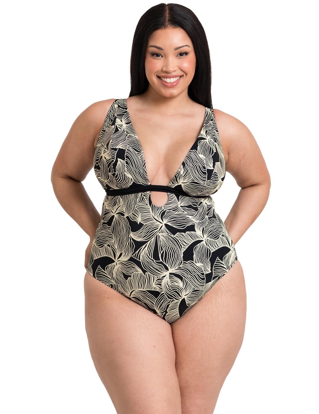 Discover your new swimwear essential this season: the Curvy Kate Ripple Reef reversible swimsuit. Featuring a deep plunging neckline, this swimsuit is designed to make you feel sexy and confident. But that's not all - it's also reversible! You heard that right, two swimsuits in one. One side boasts a classic plain design, while the other side showcases a bold and trendy graphic leaf print. This swimsuit is wireless for ultimate comfort and is also non-padded, so you can feel free and natural while rocking this look. Plus, with 3-way adjustable straps, you can customize the fit to your liking. The keyhole at the centre front adds a touch of femininity and a bit of visual interest to this already stunning swimsuit. And the moderate rear coverage provides just the right amount of cheekiness without being too revealing. Finished off with a classic back clasp closure, this swimsuit is both stylish and practical.