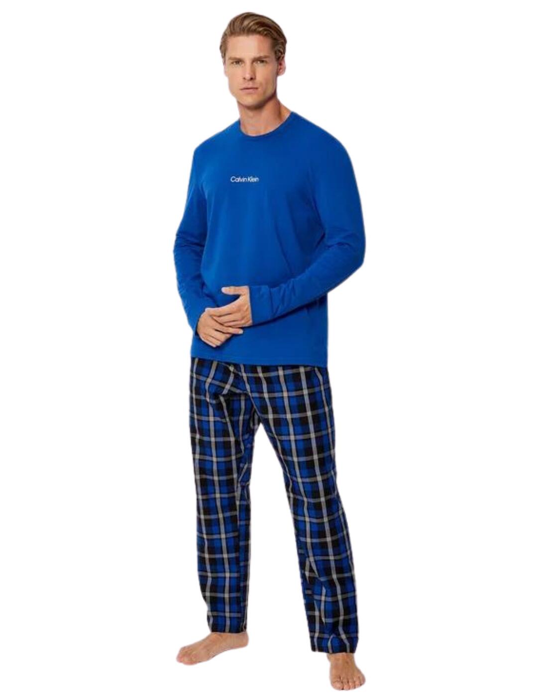 Calvin Klein's Modern Structure long-sleeved pants pyjama set is perfect for lounging around the house or getting a great night's sleep. The top is made from a soft cotton blend and features a crew neck and long sleeves for a cosy, classic look. It has the Calvin Klein logo print on the chest. The pants are made from stretchy woven cotton for ultimate comfort and stay in place with the Calvin Klein branded elastic waistband. Side seam pockets add functionality to this set and make it an ideal addition to your pyjama drawer.  Long sleeved top Crew neckline Calvin Klein logo on the chest Stretchy woven cotton pants Ankle length Side seam pockets Elastic waistband Country of origin: Sri Lanka Composition: Top: 57% Cotton &pipe; 38% Recycled Polyester &pipe; 5% Elastane Composition: Pants: 98% Cotton &pipe; 2% Elastane Listed in UK sizes  57679-101745 000NM2184E Men's Pyjama Set