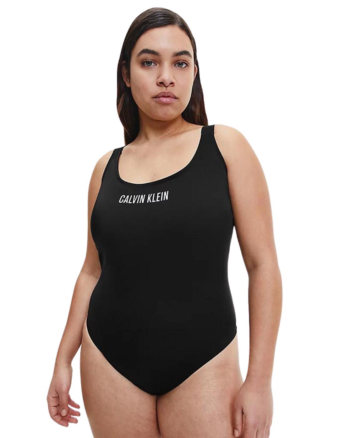 The traditional one-piece swimsuit gets a new trendy life with the Intense Power collection from Calvin Klein. This piece boasts a very simplistic design that will make your time on the beach or by the pool incredibly comfortable, but in the classic Calvin Klein style. This swimsuit features a modest scoop neckline, traditional full rear coverage and a pull-on design, offset by the alluring deep open back. The stylish athleisure look is complemented by the eye-catching Calvin Klein logo in the centre of the chest and on the wide elastic shoulder straps, giving you a swimsuit that is incredibly comfortable but still creates a bold statement in your swimwear choices.  Modest scoop neckline Deep open back Signature wide Calvin Klein shoulder straps Pull-on design Full rear coverage Non-wired Moulded cups (removable padding) Country of origin: China Composition: 78% Recycled Polyamide &pipe; 22% Elastane RRP: £75.00 Listed in UK sizes  55202-98344 KW0KW01668 Swimsuit