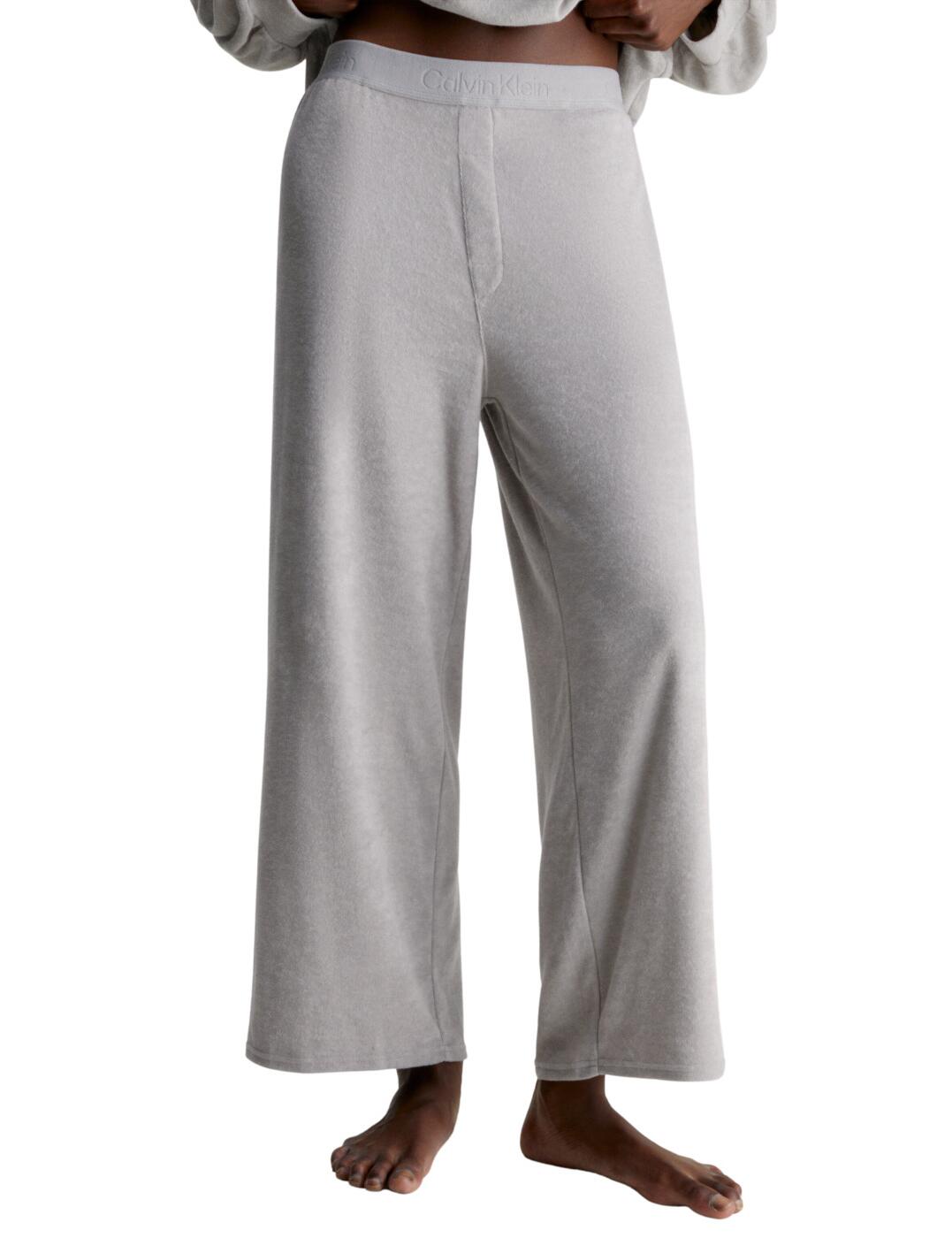 Calvin Klein Cosy Lounge pyjama pants are the perfect blend of comfort and style! They're high-waisted to give you a flattering fit and finished with a CK branded elasticised waistband. The straight-leg cut stops at the ankle, keeping you looking fresh and effortlessly stylish. Plus, they are perfect for lounging around and looking stylish all day long. So why not treat yourself today and order your Calvin Klein Cosy Lounge pyjama pants now?  Perfect and comfortable pyjama pants High rise waist Straight leg Ankle length CK branded elasticated waistband Country of origin: Sri Lanka Composition: 60% Cotton &pipe; 40% Polyester Listed in UK sizes  62784-108194-1435739 000QS7024E Loungewear