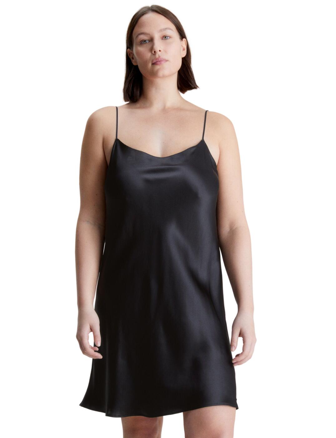 Calvin Klein's CK Black Lounge collection is defined by classic elevated designs. Crafted with sumptuous silk, this chemise is incredibly luxurious. Falling to a graceful knee-length with a flattering scoop neckline for a 90's look and feel. Featuring a flared hem with a regular fit that lightly skims over your curves for a deeply complimentary look. The shoulder straps are adjustable allowing you to tailor the fit of this chemise to suit your own personal preference.  Scoop neckline Knee-length design Adjustable shoulder straps Flared hem Regular fit Calvin Klein pendant Country of origin: China Composition: 100% Silk Listed in UK sizes  59826-104602-1375114 000QS6983E Chemise