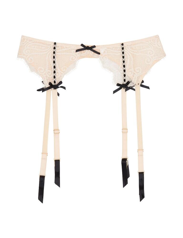 Adorn your curves with this lacy lingerie drawer staple. The Monica suspender belt by Playful Promises elevates your boudoir lingerie set to new heights. This gorgeous design is submerged in intricate lace motifs and eyelash lace detailing. Each suspender strap is decorated with a dainty rose bow adding a romantic touch. This suspender belt fastens with an adjustable hook and eye closure to the rear. For a perfect set, match with the rest of the Monica range.  Sensual and feminine design Four suspender clips Delicate lace detailing Soft handle materials 4 suspender straps Hook and eye closure to the rear Matching coordinates available Listed in UK sizes  44335-82002-1138119 PPCCSB3115P Curve Suspender Belt