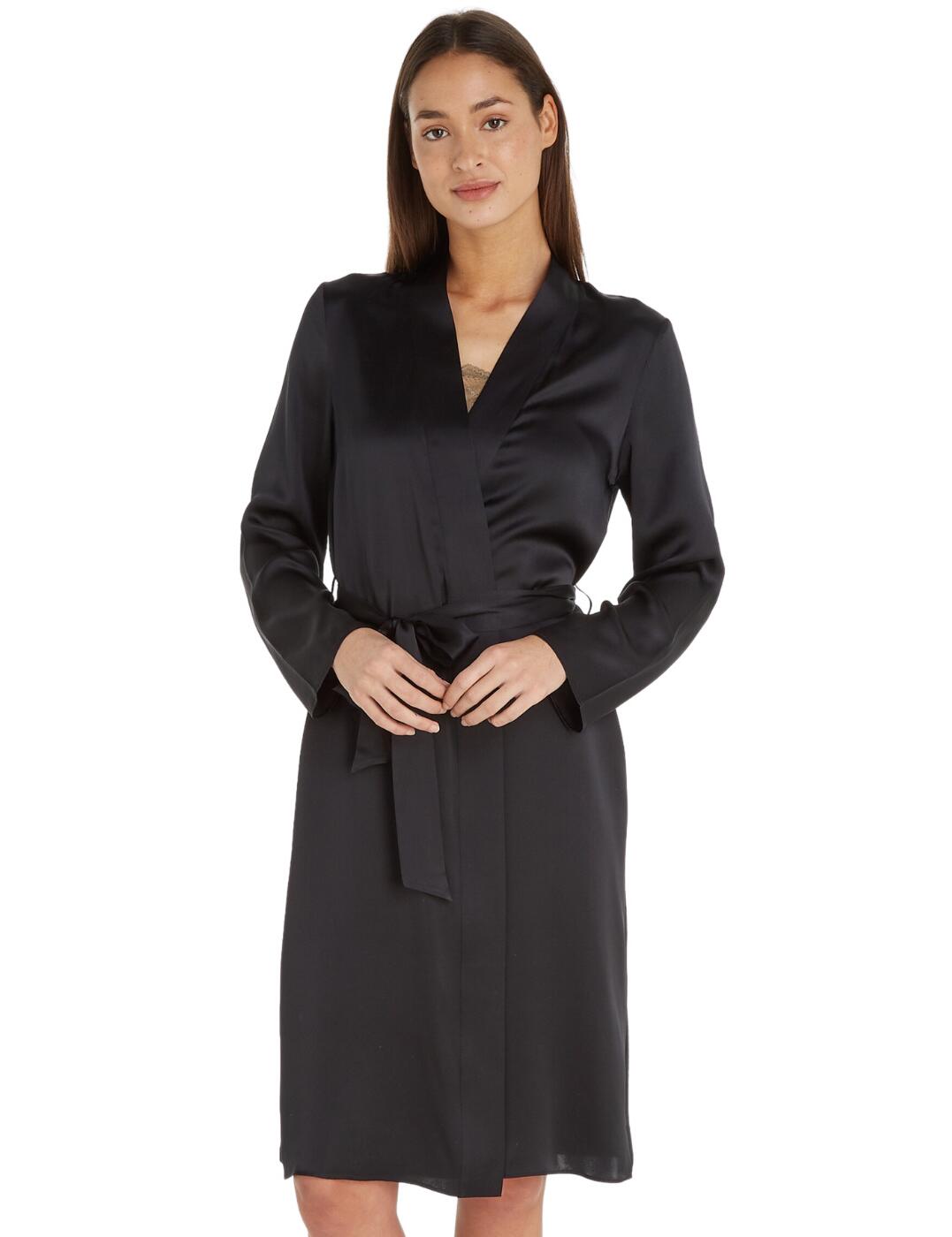 Feel luxurious this season with Calvin Klein's CK Black Lounge collection. This silk robe embodies effortless glamour, falling to a graceful knee-length with a long sleeve for a chic, classic look. The self-tie belt at the waist allows you to cinch in your silhouette to flatter and accentuate your curves. Crafted from 100% silk for a deeply sensual touch. This piece features a subtle pendant at the nape of your neck embossed with the signature Calvin Klein logo to add a designer edge to this gorgeous piece.  Wrapover styling Self-tie belt detailing Long sleeves Knee-length Calvin Klein pendant detailing Country of origin: China Composition: 100% Silk Listed in UK sizes  60071-104879-1375457 000QS6984E Dressing Gown