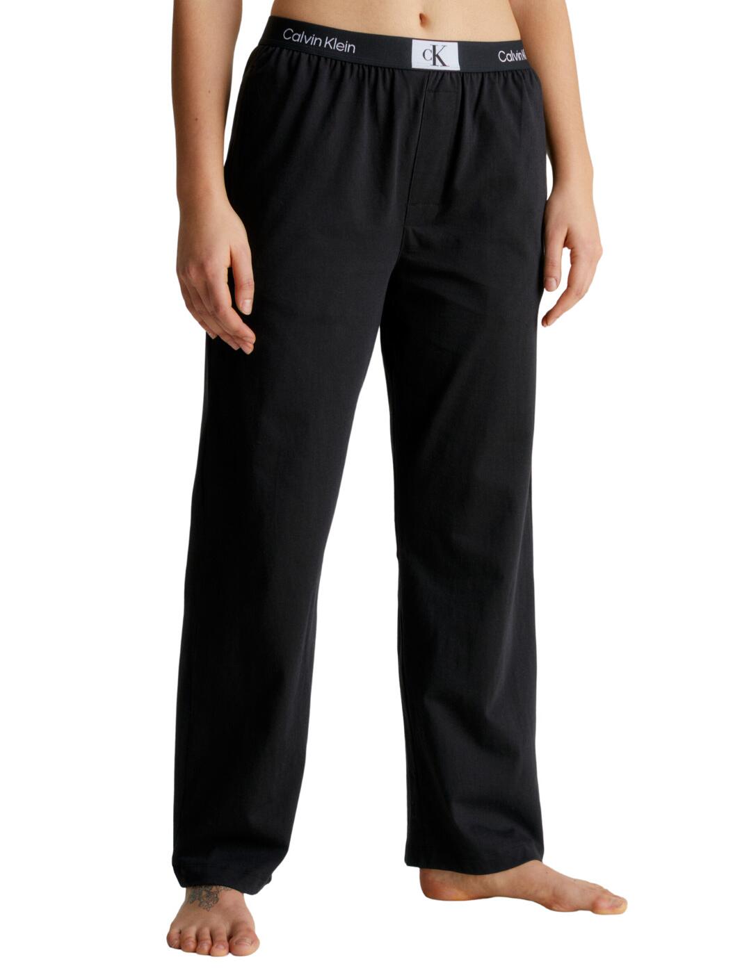 Treat yourself to the amazing comfort of Calvin Klein's classic sleep pant, the CK96s. Constructed with a mid-rise waist and straight leg cut these pants are designed to be as comfortable as possible. A soft elasticated waistband makes sure these sleep pants stay in place all night long and perfect side pockets add another touch of convenience. Of course, no Calvin Klein garment would be complete without iconic branding adding a touch of sophistication to this timeless design. To complete your look, why not check out the matching sleepwear for elegant coordination that is sure to turn heads even in your dreams!  Classic sleep pant Mid-rise waist Straight leg cut Comfortable elasticated waistband Perfect side pockets Iconic CK branding Matching sleepwear available Country of origin: Sri Lanka Composition: 80% Cotton &pipe; 20% Recycled Cotton Listed in UK sizes  62461-107816-1429351 000QS6948E Loungewear
