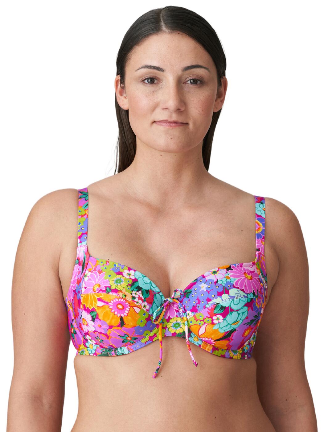 Invest in a daring, vibrant look with this luxurious full cup bikini top from Prima Donna's Najac collection! Evoking long hot days and parties on the beach, this gorgeous bikini top is bold and eye-catching thanks to the fabulously retro, 60s print. The integrated three-piece construction cups and use of underwiring lift and centre the breasts even in larger sizes, ensuring you feel supported and confident as you enjoy your day! What's more, the ties can be used to adjust the upper cups, combining with adjustable, multi-way straps to enable you to find your perfect, most comfortable fit and change up your look as you desire. Pair with coordinating bikini briefs from the Najac range to elevate your style even further!