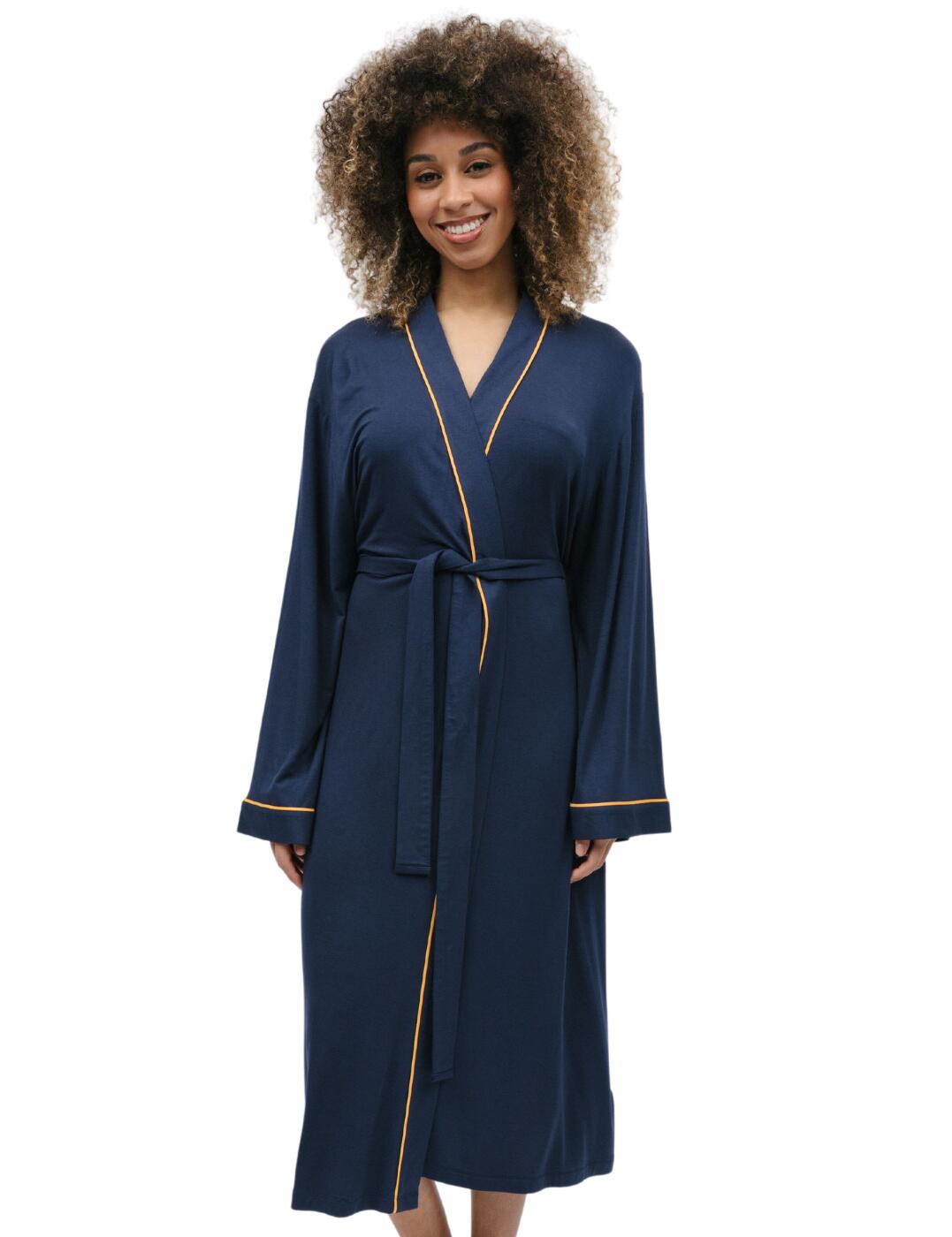 Indulge in the ultimate nightwear attire with Cyberjammies Cosmo collections long dressing gown. Complete with an elegant wrap-front design and kimono-style silhouette, this timeless classic is a true statement piece for your loungewear collection. Draping gracefully over your body the self-fabric belt helps cinch the waist and offers a customisable fit. The distinctive hue is complemented by the decorative contrasting trims, adding a subtle touch of vibrant colour to the design. Two side pockets offer practicality without compromising on style and did we mention that this dressing gown pairs effortlessly with the matching coordinates from the Cosmo and Bea range?  Dressing gown Block colour with a contrasting trim Soft stretch fabric Long sleeve Knee length Fabric tie waist Wrap over front kimono-style Matching coordinates available Country of origin: India Composition: 95% Modal &pipe; 5% Elastane Listed in UK size  9810-8 9810 Dressing Gown