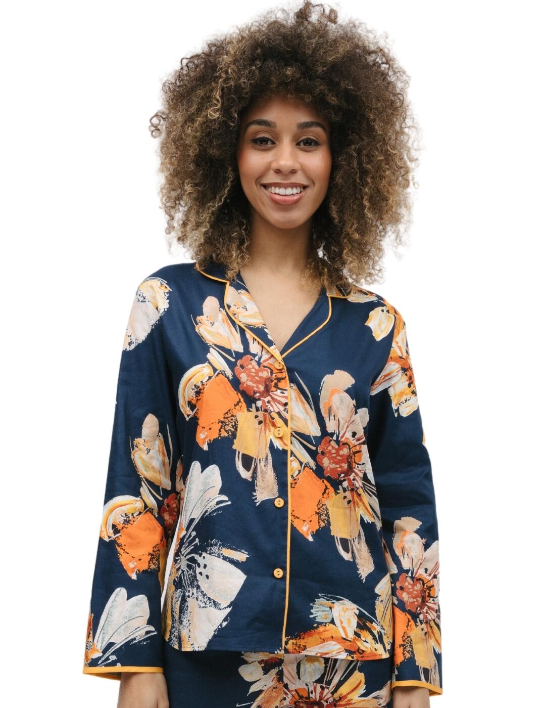 Embrace unquestionable class in the Cyberjammies Cosmo collection. The floral print pyjama top seamlessly blends comfort and style to create a sleepwear must-have. Designed with a solid base, contrasting trim and bold brushstroke florals in vibrant hues. This pyjama top is guaranteed to turn heads and make a statement. Combined with long sleeves, a revere collar and mustard-covered buttons which complete the timeless classic design, the dipped bottom hem adds a flattering silhouette to the pyjama top, ensuring you look your best even in your most relaxed moments. Make sure you shop the matching coordinates to complete your stylish look!