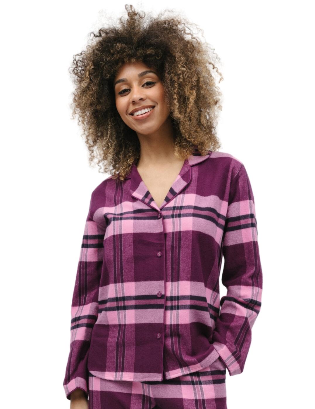 Step into superior comfort and unmatched style with Cyberjammies and its Eve range. The super cosy check pyjama top is lightweight, breathable, and crafted with you in mind. The pyjama top features a revere collar, long sleeves, a button-down front fastening and a shaped bottom hem that adds an unmistakable flattering silhouette. To complete the look why not consider pairing this top with the matching coordinates from the collection? Cyberjammies Eve super cosy check pyjama top is the perfect blend of timeless style and optimum comfort, check out with yours now!  Pyjama top Classic loose fit Checkered magenta tonal print Button down front Long sleeved Revere collar Dip hem Matching coordinates available Country of origin: India Composition: 100% Cotton Listed in UK sizes  9859-8 9859 Pyjama Top