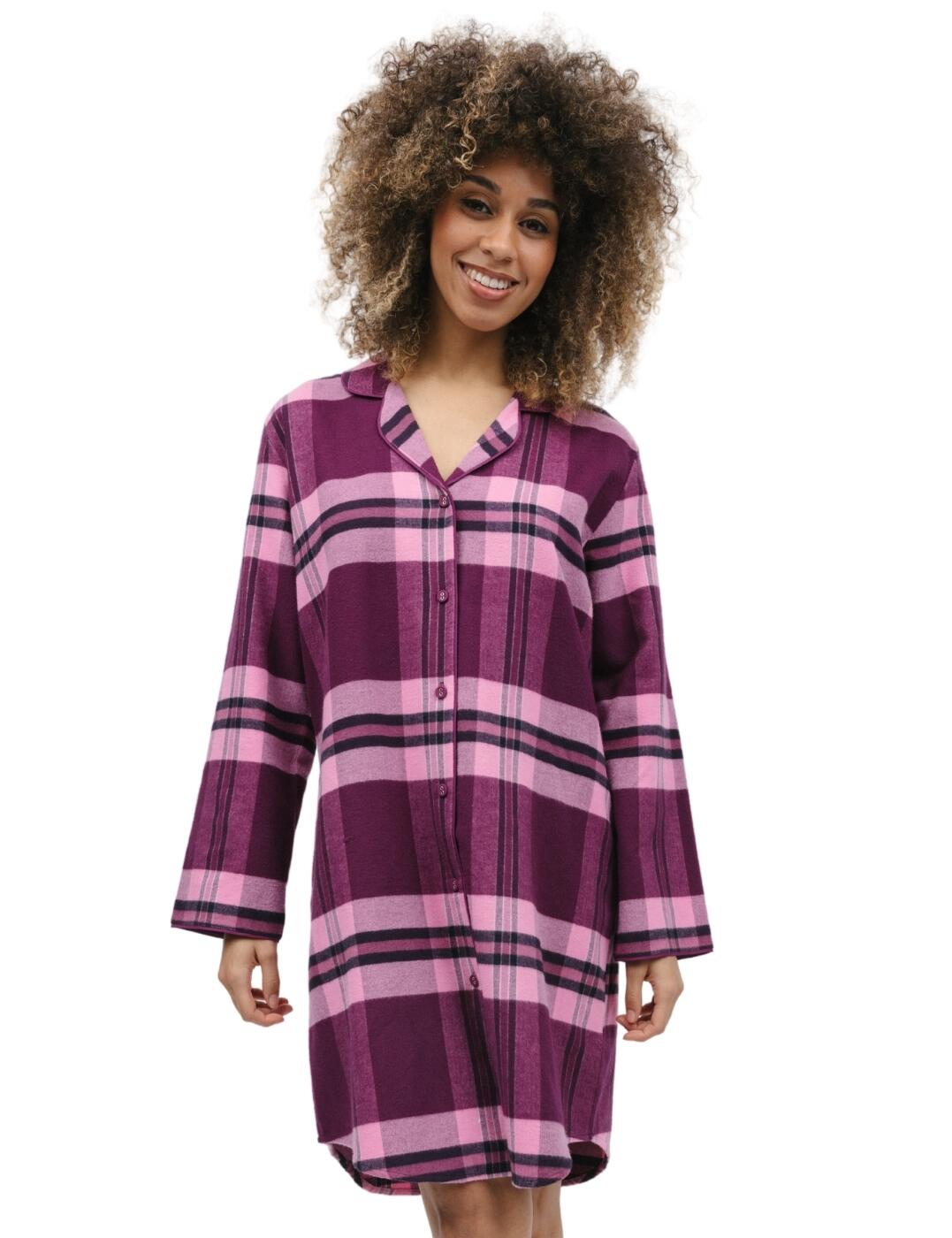 Welcome to the cosiest of nights with the Cyberjammies Eve range. The super cosy check nightshirt is a modern-day take on traditional nightwear. The timeless checkered pattern finished with button fastenings down the front, adds a subtle touch of chic to your nightwear wardrobe. The long sleeves, revere collar, and lightly shaped dipped hem give a sophisticated and feminine look with every wear. Whether you’re having a night in, winding down with a good book, or getting some much-needed beauty sleep, the Cyberjammies Eve check nightshirt provides the ultimate blend of comfort and style. Shop the matching coordinates to complete your chic new look.  Nightshirt Button down front Knee length Loose fitting Long sleeve Revere collar Dipped hem Matching coordinates available Country of origin: India Composition: 100% Cotton Listed in UK sizes  9861-8 9861 Nightshirt