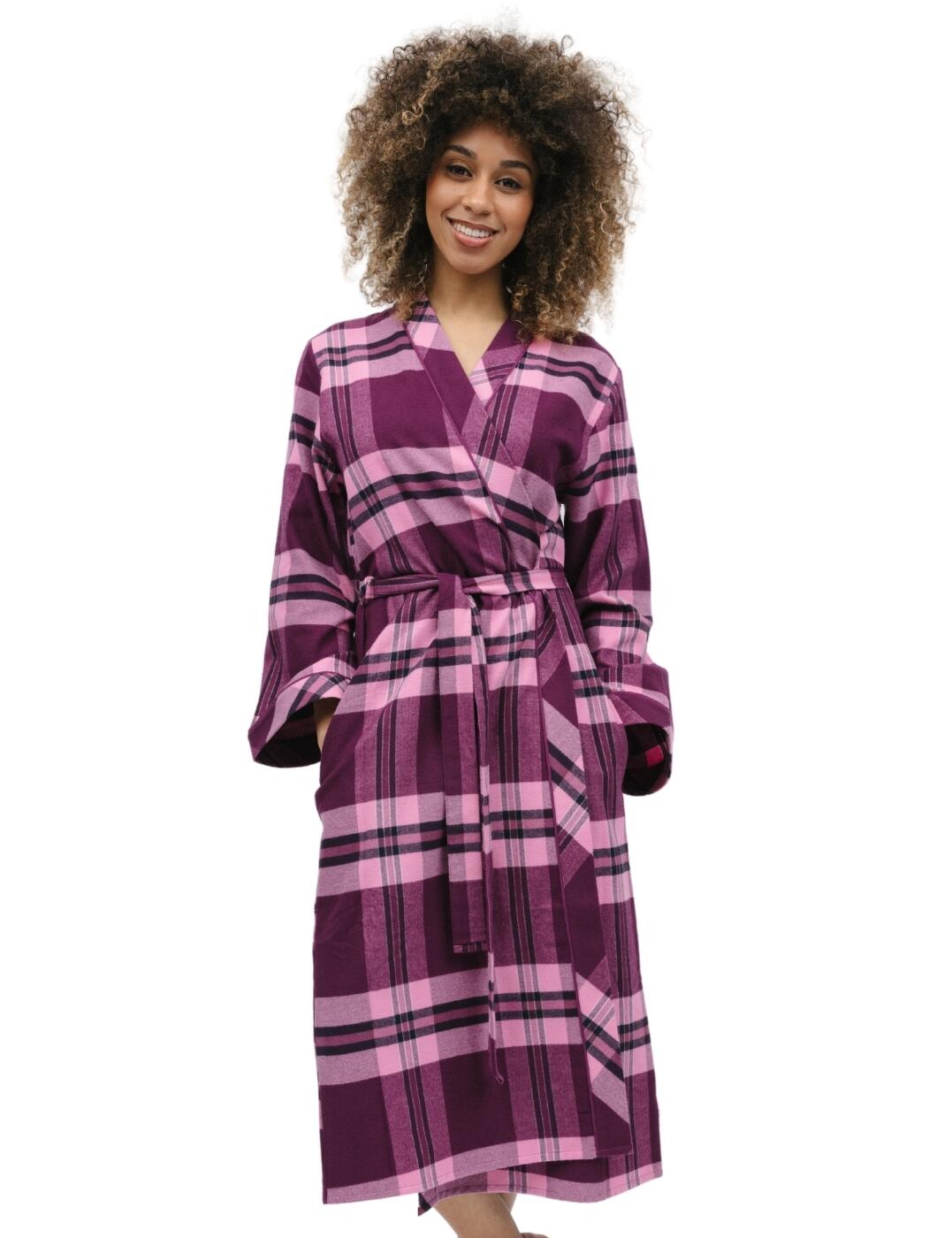 Wrap up in comfort and timeless style with the Cyberjammies Eve collection! The super cosy check long dressing gown is ideal for those who are after a striking layering piece in their sleepwear wardrobe. With a kimono-style wrap-front silhouette, this gown is sure to flatter your figure beautifully. Complete with long sleeves, two side pockets and a fabric tie belt which ensures a secure yet adjustable fit. So whether you're unwinding after a long day of work or enjoying a lazy weekend morning, this dressing gown guarantees the perfect balance of comfort and style. Fashionable and affordable, what more could you ask for? Treat yourself to the other matching coordinates from the Cyberjammies Eve range!  Dressing gown Checkered magenta and pink design Fabric tie waist Kimono-style wrap front Mid-calf length Revere collar Matching coordinates available Country of origin: India Composition: 100% Cotton Listed in UK sizes  9862-8 9862 Dressing Gown