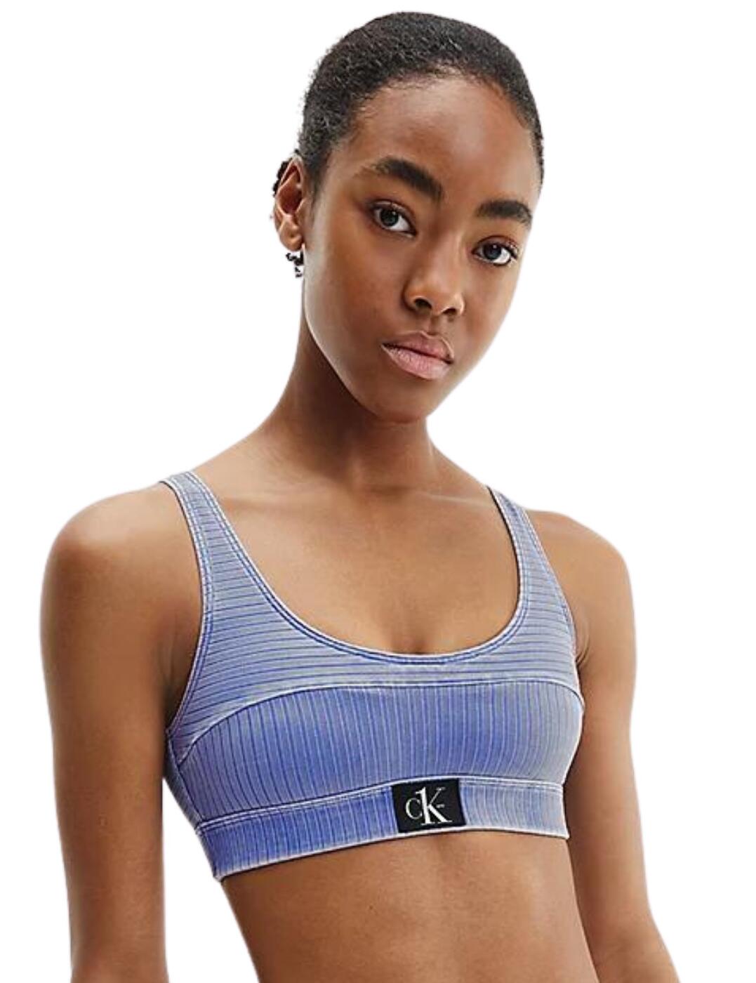 Add something a little different to your swimwear collection with the CK Authentic range by Calvin Klein which is inspired by the Calvin Klein Jeans Heritage by bringing swimwear with a washed denim look. This bralette bikini top has the classic bralette fit with full coverage, scoop back, pull-on and non-adjustable straps. It has moulded cups to provide a bust but can also be removed for a more natural fit. It has an elastic underband for comfort which has a CK logo in the centre.  Bralette bikini top Washed denim look Full coverage with moulded cups Removable padding Pull-on style Non-adjustable straps Elastic underband with CK logo at the centre Country of origin: Sri Lanka Composition: 91% Recycled Nylon/Polyamide &pipe; 9% Elastane Listed in UK sizes  56494-100260-1301002 KW0KW01753  Full Cup Bikini Top