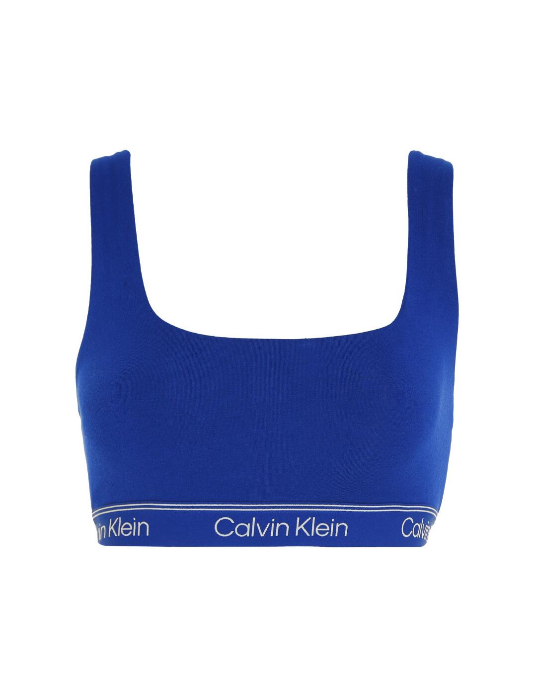 It's time to make sure your everyday lingerie is as comfortable and practical as ever! Introducing the Athletic Cotton unlined bralette from Calvin Klein. This pull-on bralette offers you good coverage and the soft cups with zero padding make it an ideal choice for everyday activities or low-impact sports. The moisture-wicking fabric ensures a dry fit, while the square neckline and signature Calvin Klein underband make this piece aesthetically pleasing. The cut-out racerback design and plain opaque fabric give you a modern, sporty look. Whether you're looking for a comfortable undergarment on your daily runs or just something practical for your daily errands, the Athletic Cotton unlined bralette from Calvin Klein is a great pick!  Bralette Soft cups with zero padding Non wired Pull-on style Offers good coverage Square neckline Moisture-wicking fabric for dry fit for everyday activities Ideal for low-impact sports Cut-out racerback design Plain opaque fabric Signature Calvin Klein underband Country of origin: India Composition: 87% Cotton &pipe; 13% Elastane Listed in UK sizes  62447-107800-1429311 000QF7185E Bralette