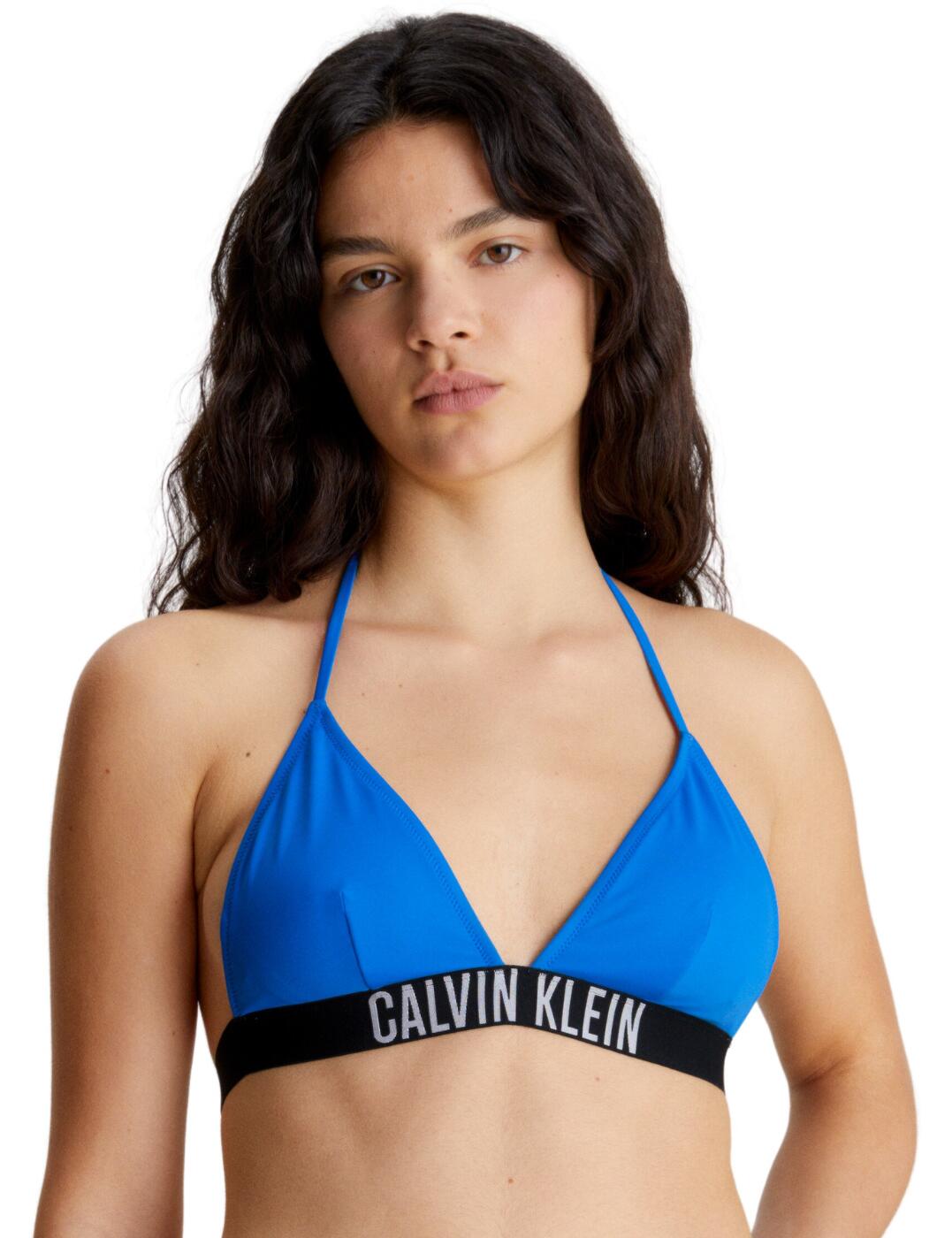 The Calvin Klein Intense Power triangle bikini top gives you a stylish and overpowering look for the beach. Crafted from smooth plain-opaque fabric, this triangle bikini top features moulded cups for structure and removable padding to ensure a perfect fit. The plunging triangle-shaped cups give your swimwear a modern edge. The branded elasticated underband provides support without compromising on fashion. A clasp closure helps you adjust the fit of the swim top and also adds an element of style. The adjustable self-tie halterneck straps provide a perfect, comfortable fit. Show off your summer style in vibrant colours with the Calvin Klein Intense Power triangle bikini top.  Triangle bikini top Moulded cups Removable padding Wireless Plunging triangle-shaped cups Smooth plain opaque design Branded elasticated underband Clasp closure at the back Self-tie halterneck straps Country of origin: Vietnam Composition: 78% Recycled Nylon &pipe; 22% Elastane Listed in UK sizes  62470-107829-1429402 KW0KW01963 Plunge Bikini Top