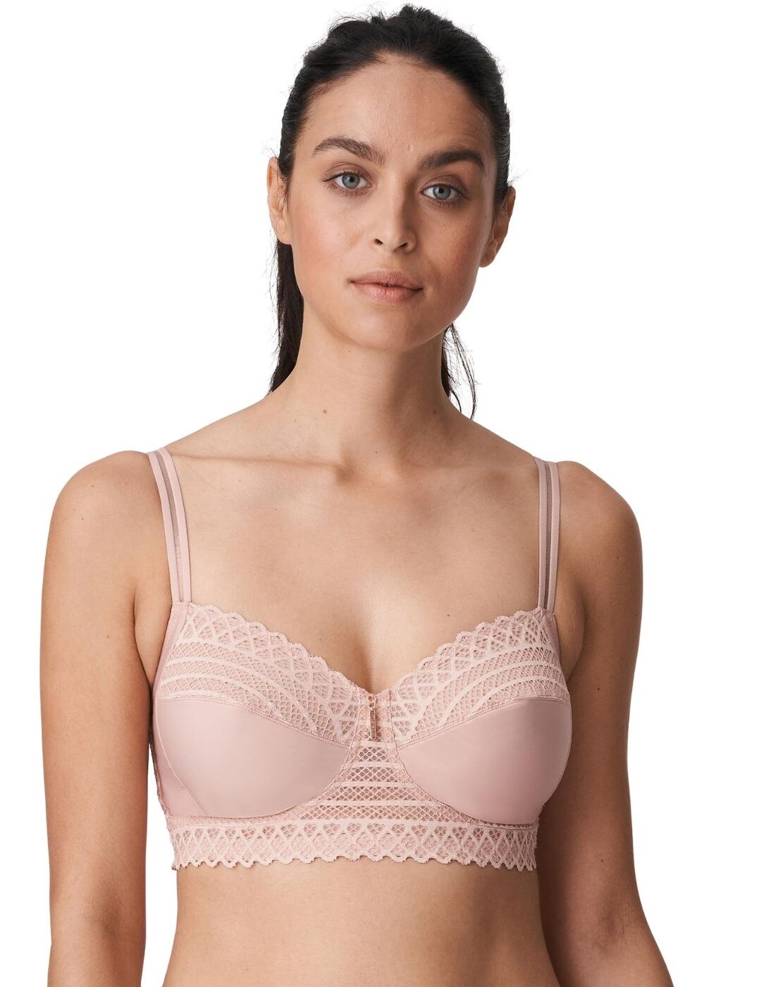 The East End collection uses seventies-inspired lace combined with modern designs for a timeless retro style. This soft cup bra flaunts premium symmetrical lace which adorns the underband and cups for a statement feminine look. A scalloped lace edge and central pendant charm add a luxurious finish to the full cup design. The lace longline underband and striped straps add a glamorous athleisure look to this classic bra. A wireless and non-padded design offers the utmost comfort that is perfect for everyday wear. Complete the perfect coordinated look with matching lingerie available from the East End range by Prima Donna.  Glamorous lace Longline underband Sporty striped straps Sexy scalloped lace edges Wireless and non-padded for comfort Adjustable straps for a unique fit Small fit: Size up one cup size from your usual Prima Donna size Composition: 82% Polyamide &pipe; 18% Elastane Listed in UK sizes  49723-89910-1189239 0141935 Longline Bra