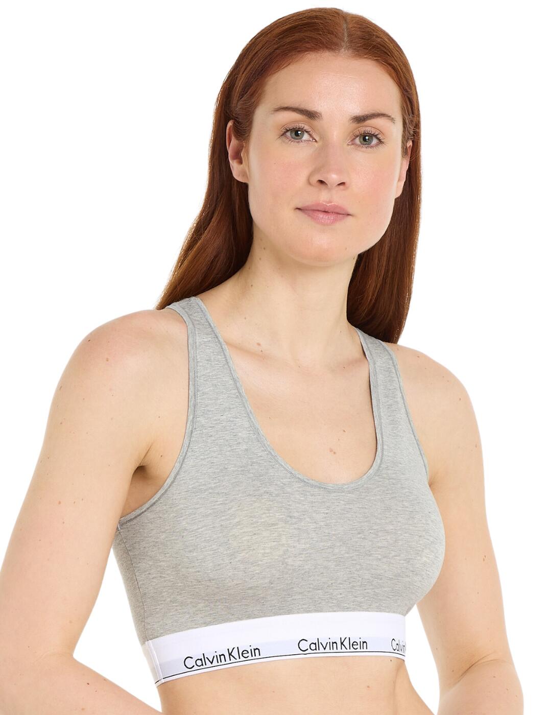The Calvin Klein Modern Cotton unlined bralette a casual, sporty lingerie staple. Expertly crafted from plain opaque fabric and designed around Calvin Klein's iconic branding, this wireless design brings you everything you need for a comfortable, confident look. The unlined, non-padded shape gives you plenty of coverage both front and back without feeling too restrictive. Non-adjustable racerback straps make it easy to slip on and ensure it stays put throughout your day. Simple yet stylish, the Calvin Klein Modern Cotton unlined bralette is perfect for any woman looking to add a touch of sporty designer charm to her everyday wardrobe.