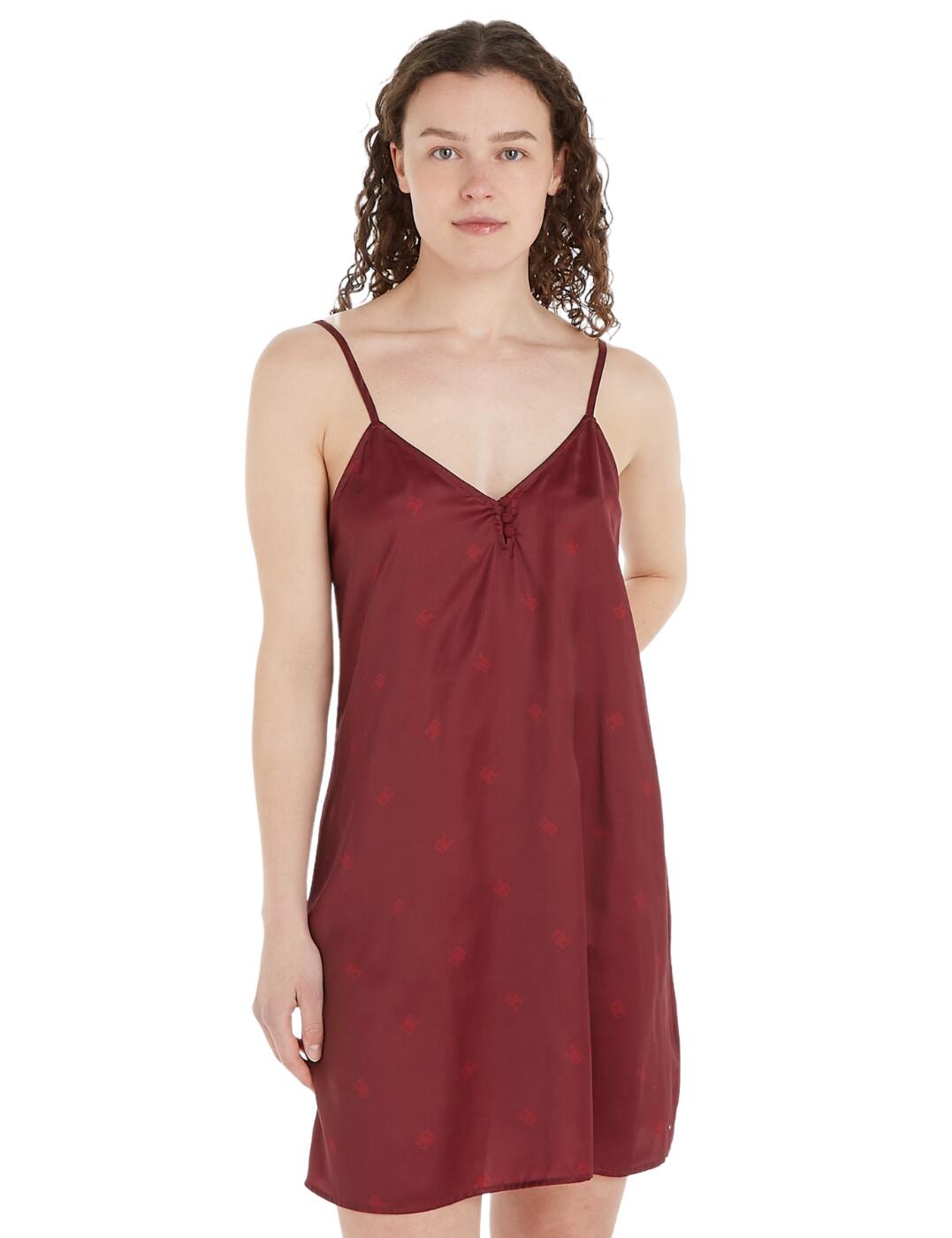 If you're looking for designer nightwear that exudes elegance and class, look no further than this luxurious satin nightdress by Tommy Hilfiger! Crafted with the iconic Tommy Hilfiger monogram print, this short length nightdress is the perfect addition to any wardrobe. Featuring a plunging neckline with delicate button details and a delicate satin feel fabric, this nightdress is sure to make you feel both comfortable and beautiful. Adjustable spaghetti shoulder straps ensure the perfect individual fit. Add a touch of designer brilliance to your nightwear routine with this luxurious nightdress.  Stylish satin nightdress Subtle monogram print Short length Adjustable spaghetti straps Plunging neckline with button detail Country of origin: Cambodia Composition: 55% Recycled Polyester &pipe; 45% Polyester Listed in UK sizes  62805-108224-1436076 UW0UW04843 Nightwear