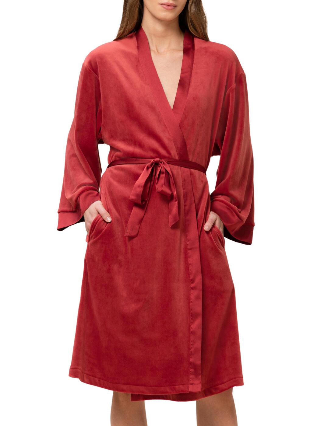 Feel classy and sophisticated in this velour robe from the Robes range by Triumph. It features an all-over block-coloured velour fabric, satin lining at sleeves and neckline, long sleeves and an easy put on style with satin ribbon waist to create a cosy fit. The robe sits at the knee creating a comfortable fit. Pair with some Triumph pyjamas for the perfect lounge/bedtime outfit.  Velour robe All-over block-coloured velour fabric Satin lining Long sleeves Satin tie waist Sits at knee Country of Origin: China Composition: 95% Polyester &pipe; 5% Elastane Listed in UK sizes  55966-99506-1307364 10213434  Dressing Gown