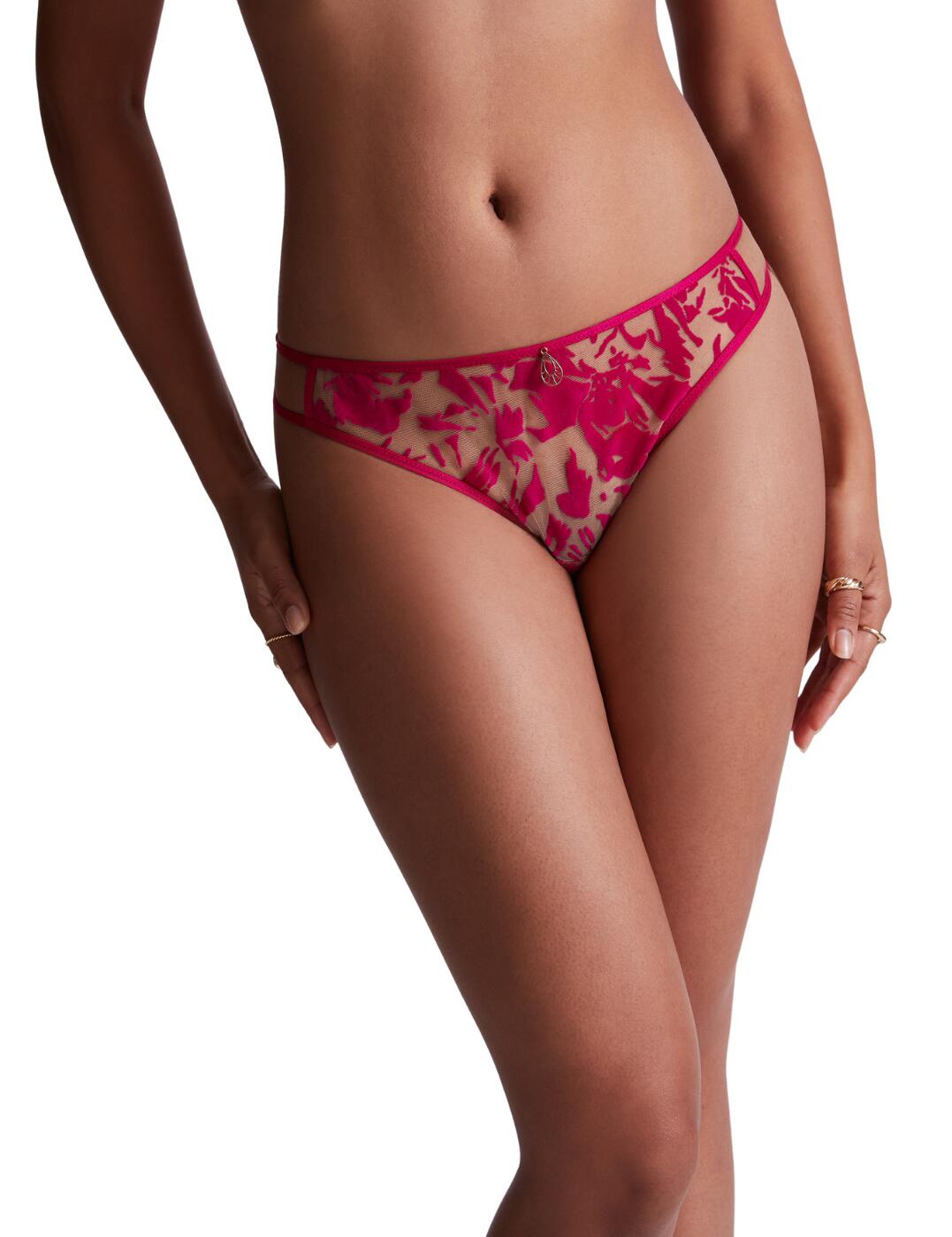 Be bold in this stunning tanga brief from the Wild Vibration collection by Aubade. Little rear coverage creates an alluring style that can't be missed. This luxurious piece is made from sheer stretch lace to expose some skin underneath. A low-rise waist, coupled with square cut leg holes creates a deepened waistband for fuller front coverage that tapers to the rear. Cut-out waistband detailing creates a strapping affect. With the cut out detailing continuing on the rear for a delicious addition. A centred pendant is added for an heir of glamour. A lined gusset is added to ensure optimal comfort whilst being worn. As well as elasticated trims for a secure fit.  Tanga brief Minimal rear coverage Sheer stretch lace Low-rise Square cut leg holes Deepened waistband Cut-out waistband Cut-out rear detailing Centred pendant Lined gusset Elasticated trims Country of origin: Tunisia Composition: Seat: 100% Cotton Composition: Outside fabrics: 100% Polyamide Composition: Tulle: 89% Polyamide &pipe; 11% Elastane Listed in UK sizes  59002-103598-1353941 LL26 Tanga Brief
