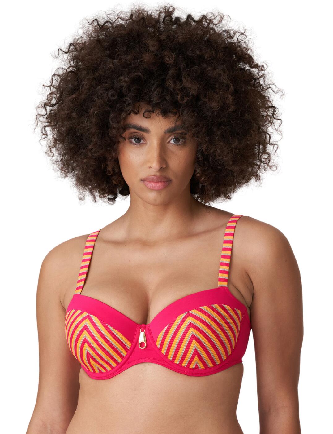 Stand out by the pool in this padded balcony bikini top from the La Concha range by Prima Donna Swim that brings luxurious swimwear with a retro feel. This bikini top has striped cups and striped straps whilst the outline of the cups and back band is crafted from a plain opaque fabric creating a bold look along with the eye-catching charm in the centre. It showcases your bust beautifully with medium coverage, padding, uplifting and supportive underwire and the sexy balcony shape. Achieve a comfortable and individual fit with the plastic clasp closure and adjustable straps that can be worn as a halterneck.