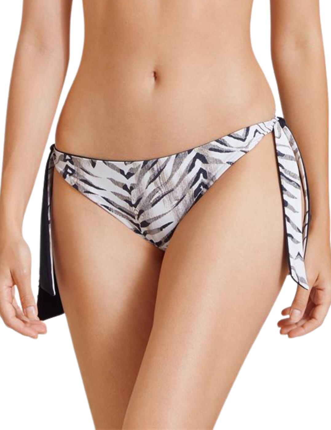 Looking stylish whilst on holiday is essential specifically at the beach/pool and this brazilian bikini brief from the Safari Sands range by Aubade will create a jaw-dropping look. The classic fit of a low-rise waist and medium rear coverage is covered in a sexy animal print on one side and plain opaque fabric on the inside which is reversible allowing you to choose your style. It is made complete with draping bows at the side which adds a feminine touch.  Brazilian bikini brief Low-rise waist Medium rear coverage Revisable design with animal print or plain design Draping bows at the side Country of origin: Vietnam Composition: Lining: 73% Polyamide &pipe; 27% Elastane Composition 2: Knit: 73% Polyamide &pipe; 27% Elastane Listed in UK sizes  56274-99929-1296050 IV20  Bikini Bottoms