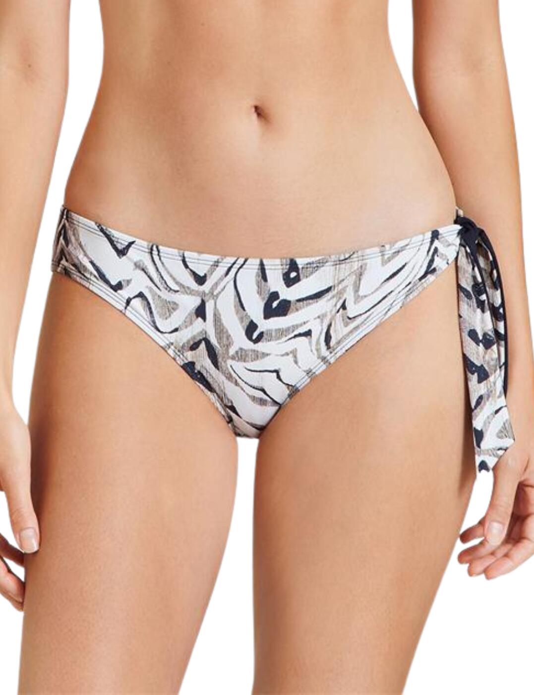 Refresh your swimwear drawer with the Safari Sands range by Aubade. This brazilian bikini brief is a must-have this summer with a flattering and classic cut with a low-rise waist and medium rear coverage as well as being covered in a fun animal print. It also features a bow that ties at the side which is also detachable allowing you to choose how to style it. Aubade provides luxury pieces and ensures comfort and the whole Safari Sands range is made from environmentally friendly fabrics. Matching bikini tops are available to create a stylish beach look.  Brazilian bikini briefs Low-rise waist Medium rear coverage Fun animal print Side bow Made with environmentally friendly fabrics Matching bikini tops are available Country of origin: Vietnam Composition: Lining: 90% Polyester &pipe; 10% Elastane Composition 2: Knit: 73% Polyamide &pipe; 27% Elastane Listed in UK sizes  56275-99930-1296055 IV22  Bikini Bottoms