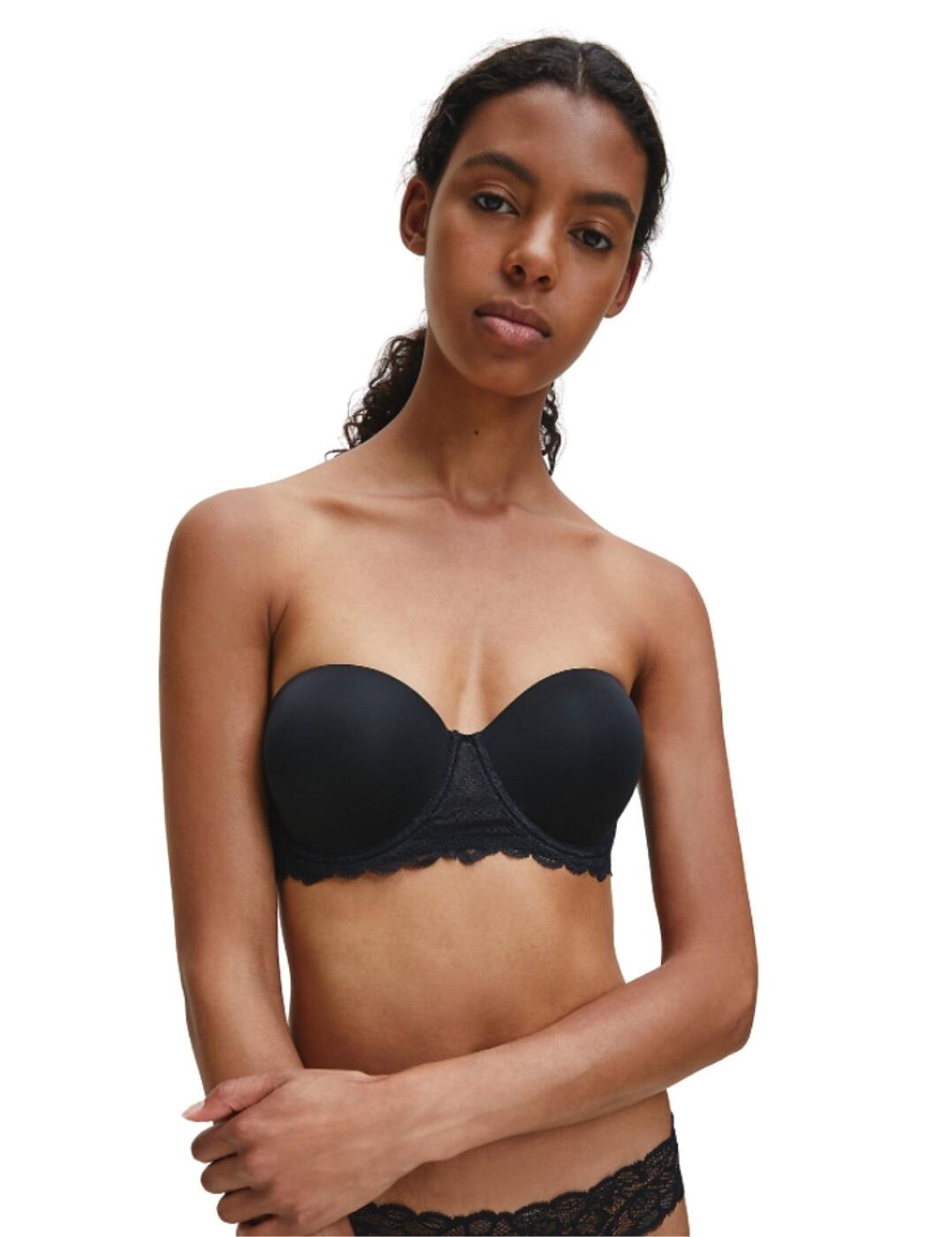 This strapless bra from the Seductive Comfort range at Calvin Klein offers a versatile style with feminine lace detailing for a fantastic bra for many occasions. The cups are underwired to keep the bust support throughout, whilst the minimal detailing on the cups allows for great invisibility under clothing. It offers detachable shoulder straps so you can mix up how you wish to wear it. Delicate semi-sheer lace and scalloped edges brings detail and a femininity to this bra.  Versatile and feminine design Underwired Detachable straps Semi-sheer lace and scalloped edge details Hook and eye closure Composition: 78.5% Nylon &pipe; 21.5% Elastane Listed in UK sizes  48547-88141-1167318 QF1437E Strapless Bra