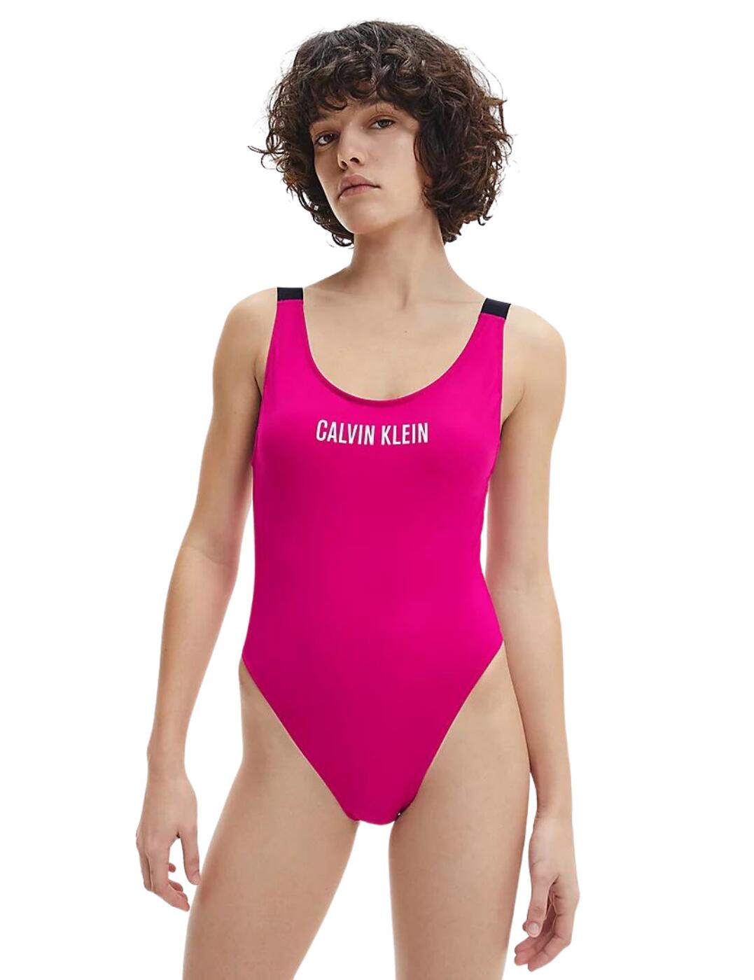 Make summer your season with the gorgeous athleisure Intense Power collection by Calvin Klein. This one-piece swimsuit plays off of the traditional swimsuit design but adds subtle changes to highlight your figure. The modest scoop neckline is offset by the deep open back, while the simplistic design is made that much more appealing by the trendy Calvin Klein logo in the centre of the chest and on the iconic elastic shoulder straps. As a final touch, the high-cut sides lengthen your legs and, combined with all the rest of the small refinements, create an alluring silhouette.  Modest scoop neckline Deep open back High-cut sides Elastic shoulder straps with Calvin Klein logo Moderate rear coverage Pull-on design Non-wired Moulded cups (removable padding) Country of origin: China Composition: 78% Recycled Polyamide &pipe; 22% Elastane Listed in UK sizes  55256-98843-1285512 KW0KW01597  Swimsuit