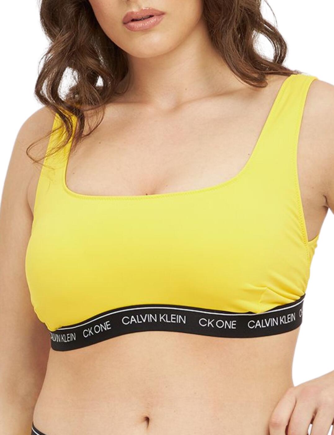 This bikini top from the CK One collection flaunts Calvin Klein's iconic sports-luxe style. Designed specially for plus sizes, this bralette offers support and comfort. The sporty design boasts a rounded neckline and the Calvin Klein branded under-band adds a designer finish. Non-wired for comfort and the lightly lined cups create a smooth finish.v Complete the look with matching swimwear from the iconic CK One collection by Calvin Klein.  Iconic Calvin Klein branded under-band Designed for plus sizes Rounded neckline Pull-on design Lightly lined cups Supportive elastane under-band Non-padded Non-wired Country of origin: Sri Lanka Composition: 83% Polyamide &pipe; 17% Elastane Listed in UK sizes  55446-98844-1285392 KW0KW01793  Plus Swim Bralette