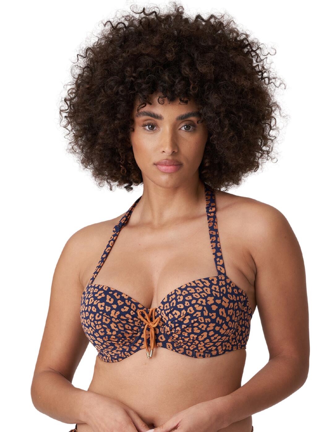 Create a fun and stylish look with this balcony bikini top from the Punta Rata collection by Prima Donna. The jacquard fabric creates a modern look, ruched in the centre to create a curve enhancing look. The sweeping sweetheart neckline meets in the centre for a rope inspired bow with golden stoppers that don't get hot in the sun! This neckline highlights your perfectly uplifted bust thanks to the firm padding within the bra, and the flawlessly installed underwiring that still ensures a comfortable fit. The straps are adaptable meaning they can be changed to a racerback, so you can style the piece however you wish.  Adjustable straps Plastic snap back clasp fastening Adaptable straps so they can be changed to a cross-back Gold toppers that don't get hot in the sun Rope inspired bow Ruched detailing Underwired Padded Sweeping sweetheart neckline Country of origin: China/Nanhai Composition: 58% Polyamide &pipe; 31% Polyester &pipe; 11% Elastane Listed in UK sizes  57693-101763-1319324 4010016 Balcony Bikini Top