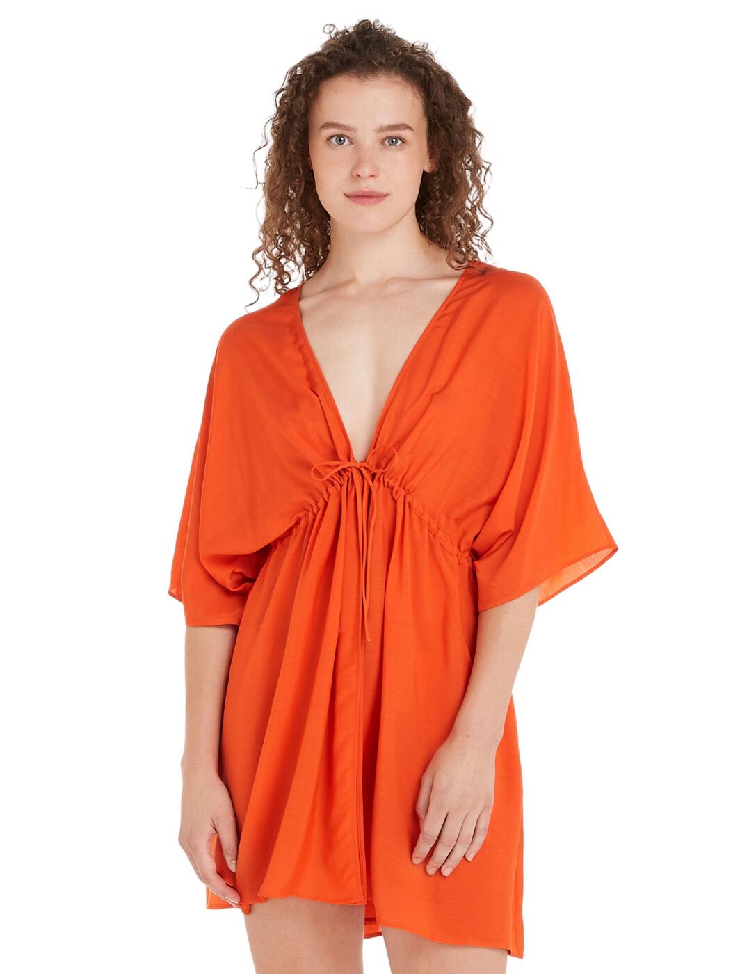 When you're not sunbathing on the beach or by the pool, make sure that you stay in style by wearing this gorgeous cover-up from Tommy Hilfiger. A simplistic design will not detract from your trendy swimwear look but will subtly enhance it. This piece is done in an oversize style with half sleeves and an approximate mid-thigh length, closing at the front with a string tie-up. A fine Tommy badge on the bottom finishes off the trendy look.