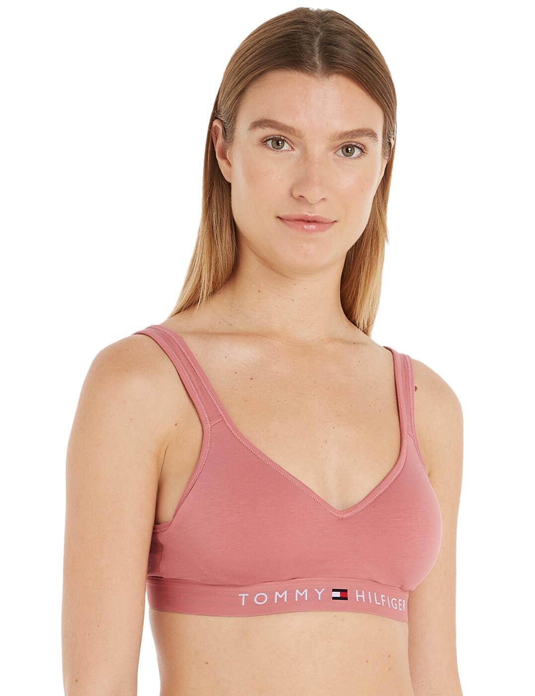 Discover the new Tommy Hilfiger bralette, designed for ultimate comfort and support. Featuring padded moulded cups, a wireless design, and a hassle-free pull on style with fixed straps, it provides a soft and smooth fit. The stylish elasticated underband with the Tommy Hilfiger logo adds a touch of signature branding. Pair it with matching briefs for a complete look. Upgrade your undergarment collection with this comfortable and stylish piece.