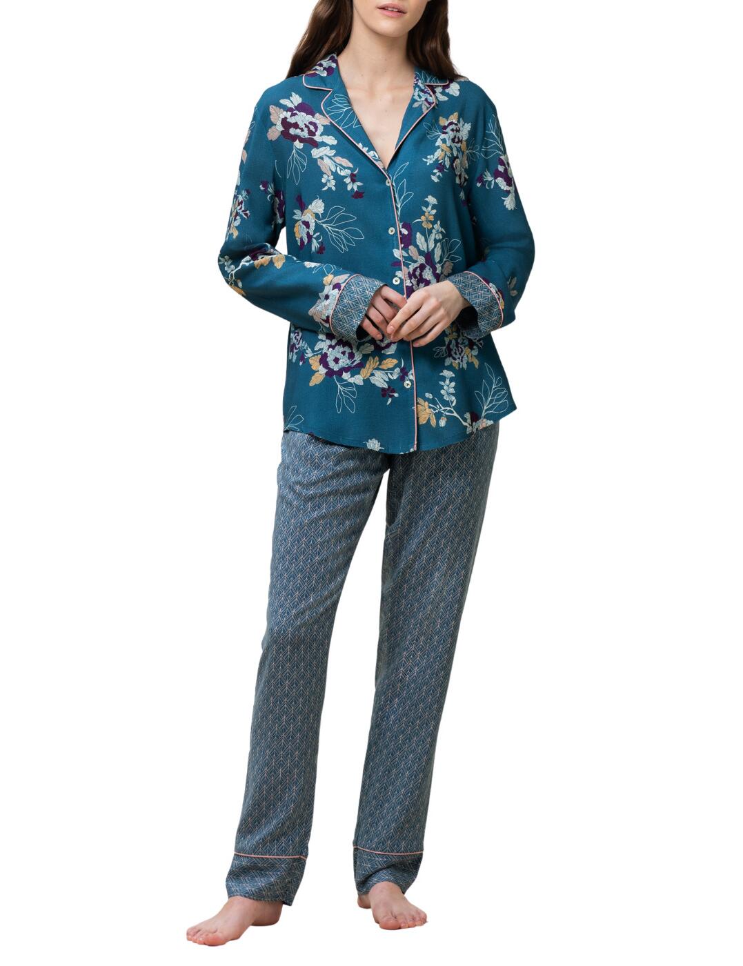 Keep cosy in this beautiful floral printed pyjama set from the Boyfriend range by Triumph. The floral print on the shirt perfectly couples with the shirt colour to create a stunning feminine and elegant look. A smooth chelsea collar highlights your décolletage whilst descending into the contrasting hem, elegant to even the finer details. Each sleeve is cuffed with a geometric pattern, that is seen on the trousers, to continue the theme through the piece. The trousers have a tie waistband allowing you to tighten or loosen the fit however you wish. The soft fabric drapes off your curves allowing perfect freedom of movement and upmost comfort.  Soft chelsea collar V-neck Contrasting hem Floral pattern Drawstring waist loose-fitting Button-down shirt Country of Origin: Bangladesh Composition: 100% Viscose Listed in UK sizes  56166-99744-1301746 10213405  Pyjamas
