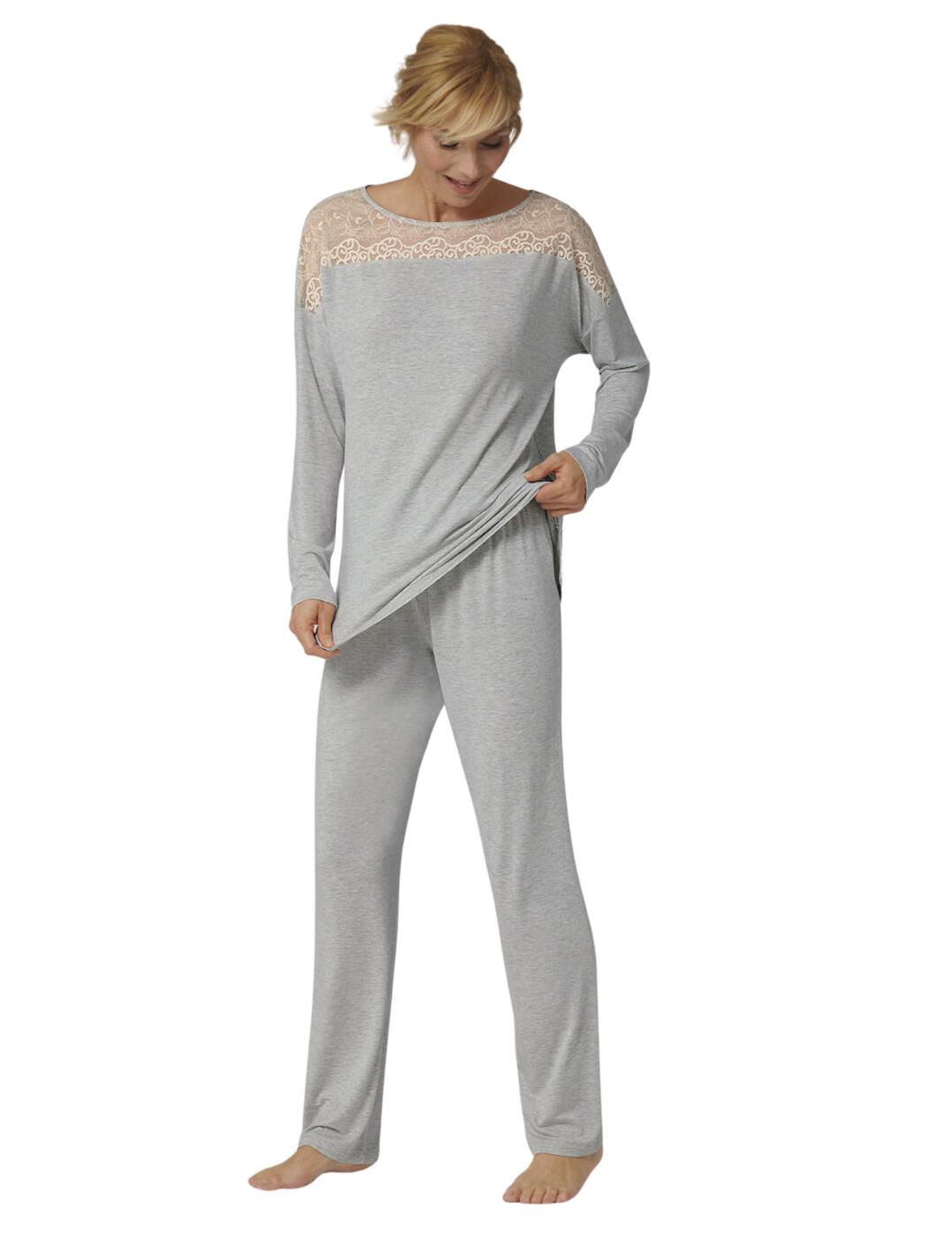 Elevate your loungewear with Triumph's elegant Amourette collection. This pyjama set brings pure comfort to your nightly routine with the luxuriously soft jersey that gives a breathable and comfortable fit with every wear. This set includes a gorgeous long sleeve top that boasts a relaxed fit and cosy pyjama bottoms that have a soft relaxed feel. The top features a beautiful contrasting lace detail that adorns your decolletage creating a feminine finish. The bottoms are full length and feature a soft stretch waistband that provides premium comfort to this gorgeous 2 piece set.  Long sleeve Contrasting lace detailing on neckline and shoulders Relaxed loose fit Matching set Stretch waistband Round neckline Country of origin: Cambodia  Composition: 95% Viscose &pipe; 5% Elastane  Listed in UK sizes  56526-100294 10209624 Pyjama Set