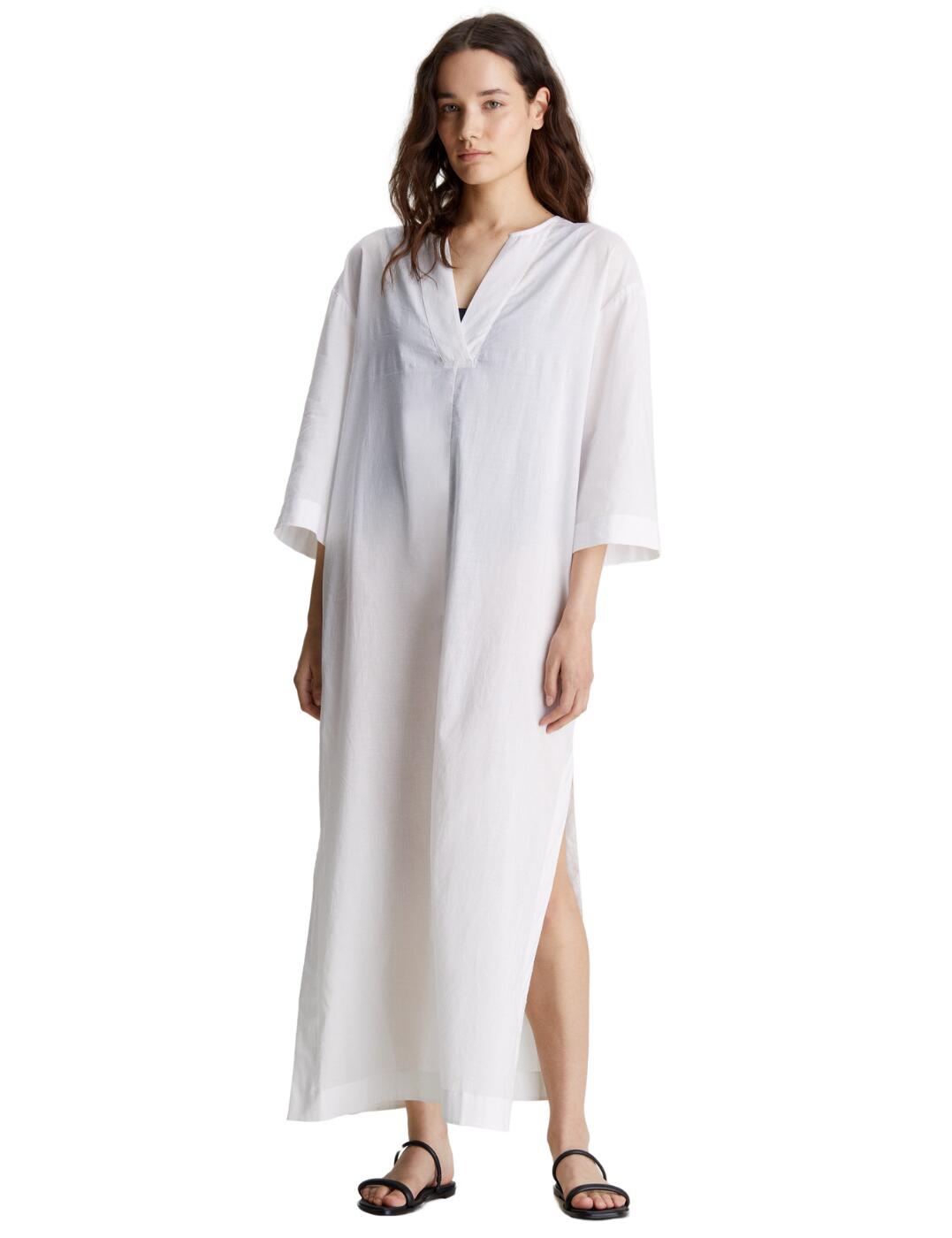 Upgrade your poolside style with this Calvin Klein cover-up this season. Crafted from a semi-sheer, lightweight fabric, this long cover-up effortlessly drapes over your swimsuit, creating a casual bohemian look. The relaxed fit and 3/4 length sleeves allow for easy movement and ultimate comfort, while the V neckline adds a touch of femininity. A tie fastening at the back of the neck not only adds extra detail but also ensures a secure fit. The iconic Calvin Klein metal tag at the back adds a touch of designer statement, while the V-shaped back adds a subtle yet fashionable element to the design.