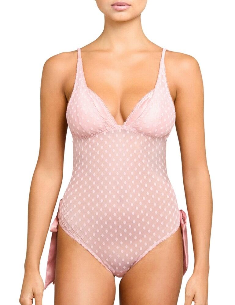 Enhance your best assets with the Roxanne bodysuit by Coco De Mer. This soft and feminine design allows for subtle hints of sexiness without baring too much. Elegant sheer mesh is designed with playful polka-dots, tied together by oversized satin bows. The Roxanne bodysuit features a plunging neckline, highlighting your cleavage perfectly. The shoulder straps are fully adjustable and the bodice fastens with a hook and eye closure at the rear. Your back is revealed with a peep-hole design at the rear, encouraging attention to your perfect derriere.  Stunning, feminine design Contemporary polka dots Bows on the sides Non-wired and non-padded cups Silk-lined cups Adjustable straps Secures at the rear with a hook and eye Moderate rear coverage Composition: 50% Polyester &pipe; 45% Polyamide &pipe; 5% Elastane Listed in UK sizes  46211-85365-1136175 ROX-022-04 Body