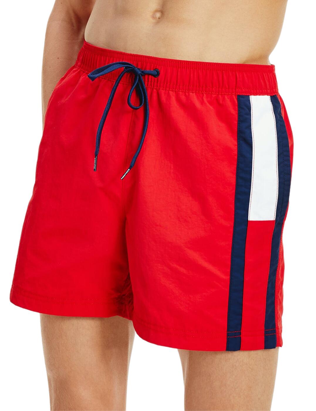 Tommy Hilfiger is renowned for its premium fashion in a timeless sports-luxe style. These drawstring swim trunks boast a bold graphic pattern that subtly incorporates the iconic Tommy Hilfiger flag logo. The flattering mid-thigh length and adjustable drawstring tie create the perfect individual fit. Side pockets and a soft mesh lining offers a practical design that is perfect from beach to bar. Wear with matching Tommy Hilfiger accessories for a designer beachwear look!  Bold graphic design Regular fit Adjustable drawstring tie Tommy Hilfiger flag detail Comfortable mesh lining Side pockets and back pocket Mid thigh length Composition: 100% Recycled Nylon Listed in UK sizes  51188-92419-1228774 UM0UM01697 Men's Drawstring Swim Trunks