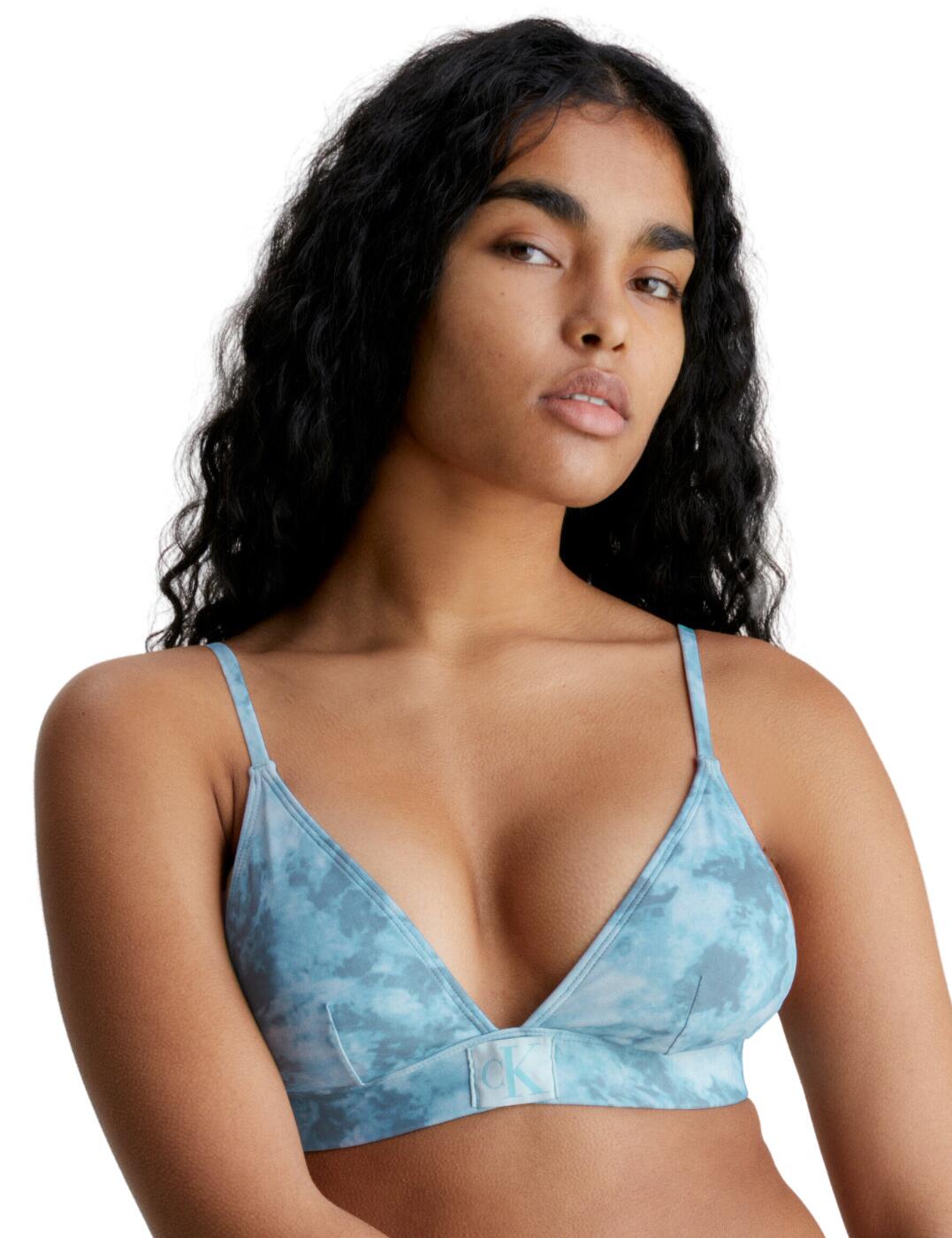 CK Authentic reimagines swimwear to be unique and stylish. This triangle bikini top falls to a deeply flattering plunging neckline and features wire-free cups that boast removable padding for a more refined look to the bust. With the all-over tie-dye print, this triangle bikini top has a unique look that is bound to turn heads. The soft elasticated underband supports your curves whilst still ensuring premium comfort. The Calvin Klein badge detailing on the centre of the underband gives this piece that instantly recognisable flair. Complete the set with the available matching items within the CK Authentic collection.  Pull-on design Signature Calvin Klein elasticated underband Adjustable shoulder straps Tie-dye print Removable padding Wire-free Calvin Klein logo badge Plunging neckline Matching coordinates available Country of origin: Sri Lanka Composition: 83% Recycled Nylon &pipe; 17% Elastane Listed in UK sizes  59817-104593-1425878 KW0KW02121 Plunge Bikini Top