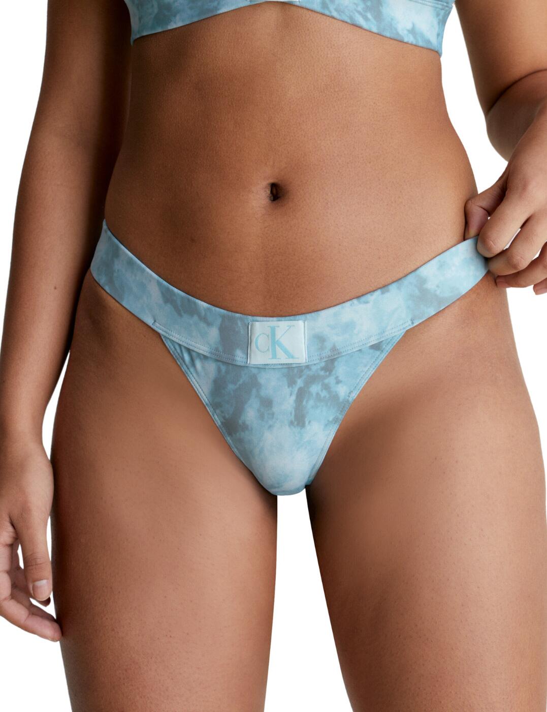 Calvin Klein's CK Authentic makes a splash this season with these on-trend bikini briefs. Featuring a minimal rear coverage for a deeply flirtatious fit coupled with the low-rise waist that flatters your hips. The all-over tie-dye print adds a unique, effortlessly cool flair to this classic design. The soft elasticated waistband features the signature Calvin Klein 'CK' logo for a chic edge. Complete this iconic set with the available matching items within the CK Authentic line.  Low-rise waist Fully lined All-over tie-dye print Calvin Klein logo badge on centre waistband Minimal rear coverage Matching coordinates available Country of origin: Sri Lanka Composition: 83% Recycled Nylon &pipe; 17% Elastane Listed in UK sizes  59818-104594-1425874 KW0KW02126 Bikini Bottoms