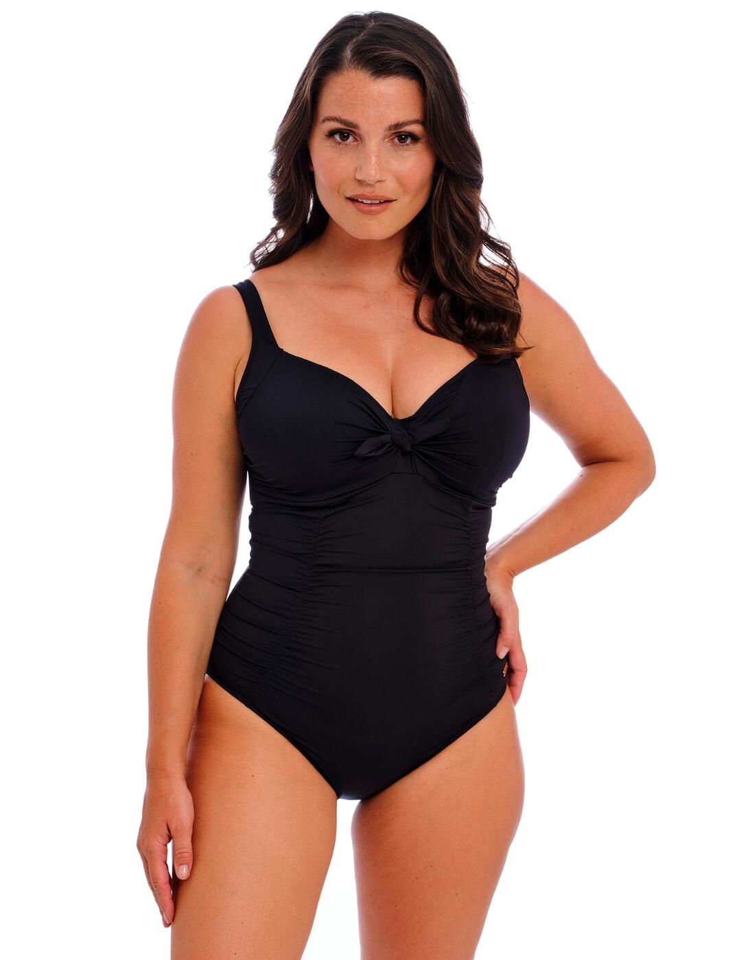 Refresh your staple swimwear collection with this classic swimsuit from Fantasie's Merissa range. With a concealed underwire for support and flattering, moderate bust coverage, this swimsuit is a holiday essential, sure to keep you confident and supported wherever you go. The swimsuit features a figure-flattering ruched centre panel, complete with light smoothing control to suit your shape and a feminine bow tie between the bust for a playful flair. Support is offered by a powernet-lined back wing and full lining, with a custom fit offered by fully adjustable shoulder straps. Plus, the sustainable regenerated fabrics mean your swimwear is good for the environment as well as your sunbathing!