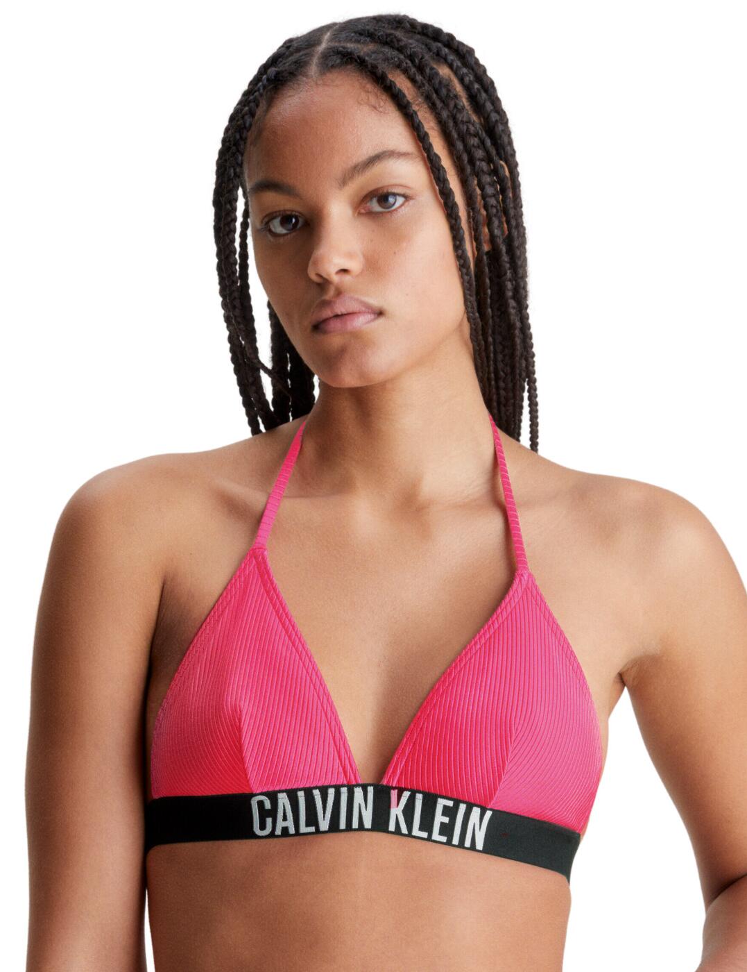 When beach days come calling, make sure to give your swim wardrobe an upgrade with our newest Calvin Klein Intense Power triangle bikini top. In a flattering high shine ribbed material, you can make a stylish statement this season without compromising on comfort. Plus, the self-tie straps at the neck and wireless design make it perfect for all-day wear. The removable moulded triangle cups and clasp fastening at the back provide a secure fit that is comfortable. Its iconic Calvin Klein signature elastic underband also adds a modern feel – perfect for lounging poolside. This bikini top is perfect for any beach babe, so make sure to get your hands on this piece today!  Plunging neckline Clasp fastening at the rear Removable moulded cups Designer Calvin Klein stretch underband Self-tie halterneck straps Rib texture Non-wired Country of origin: China Composition: 85% Recycled Nylon &pipe; 15% Elastane Listed in UK sizes  61740-106906-1423206 KW0KW01967 Plunge Bikini Top