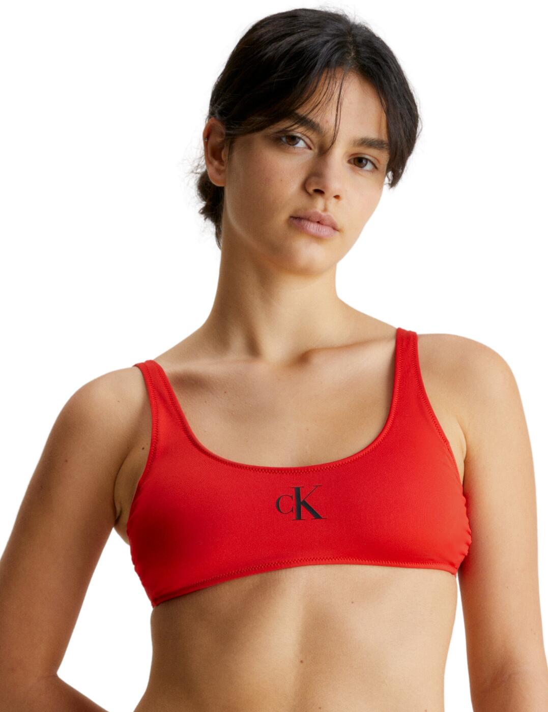 Shake up your style with the Calvin Klein CK Monogram bralette bikini top. Boasting an eye-catching design that blends old and new, this piece is perfect for women who want to step into the new season with a truly unique look. Made from a polyester elastane blend for the ideal combination of comfort and softness, this bikini top also features a scoop neckline, soft moulded cups and removable padding for superior support. Featuring a wireless design for even more comfort, this summer essential is complete with the iconic Calvin Klein monogram logo on the chest. So if you’re looking for something really special to make waves this season, the Calvin Klein CK Monogram bralette bikini top is the perfect choice.  Signature Calvin Klein logo detailing Scoop neckline Soft and comfortable Fixed straps Pull on design Removable padding Moulded cups Wireless Country of origin: Sri Lanka Composition: 85% Recycled Polyester &pipe; 15% Elastane Listed in UK sizes  61742-106908-1423139 KW0KW01971 Padded Bikini Top
