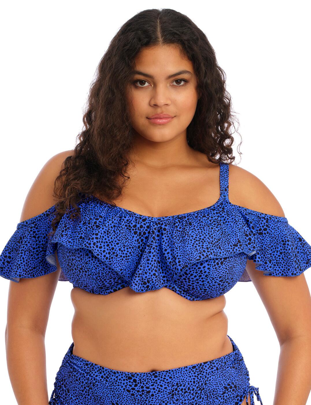 Get ready to turn heads at the beach or by the pool with the Elomi Pebble Cove underwired bikini top. With its feminine ruffle shoulder detail, this bikini top adds a touch of elegance and playfulness to your look. The full cup design provides ample coverage and support, so you can feel secure and free to enjoy your time in the sun. No need to worry about transparency, as this bikini top is fully lined for your peace of mind. The stylish printed material is eye-catching and on-trend. The non-padded cups offer a natural look and feel, and with the underwired construction, you can trust that this bikini top will provide the lift and shape you desire. Adjustable shoulder straps ensure a personalized fit, so you can find your perfect level of comfort. Don't forget to complete your beach-ready look with the matching coordinates available. So, ladies, if you're looking for swimwear that combines style, comfort, and confidence, look no further than the Elomi Pebble Cove underwired bikini top.  Feminine ruffle shoulder detail Full cup design Stylish printed material Fully lined Non-padded Underwired Adjustable shoulder straps Classic swimwear clip fastening Matching coordinates available Country of origin: Indonesia Composition: 82% Polyamide &pipe; 18% Elastane Listed in UK sizes  61810-107001-1416680 801106 Full Cup Bikini Top