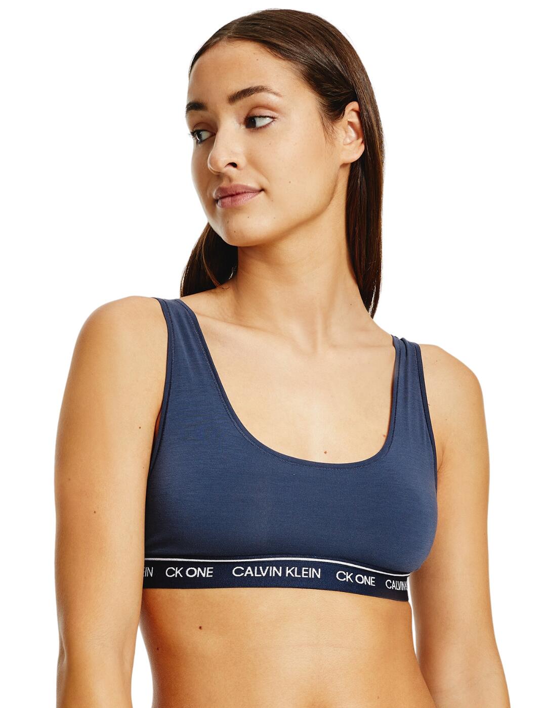 5d The CK One Recycled collection blends Calvin Klein's iconic lingerie designs with innovative eco-friendly fabrics. This unlined bralette has an easy pull-on design with a fixed non-adjustable strap for a comfortable design that is perfect for everyday wear. The supportive elasticated underband subtlety shows the Calvin Klein signature logo adding a sports-luxe finish. Matching lingerie is available from the CK One Recycled range for the complete coordinated look.  Non-wired cups for comfort Non-padded design for a natural look Calvin Klein logo features on the waistband Pulls on over the head with no rear closure Fixed and non-adjustable straps Comfortable, soft fabric Country of origin: Sri Lanka Composition: 89% Recycled Polyester &pipe; 11% Recycled Elastane Listed in UK sizes  51895-93523-1238038 000QF6502E  Unlined Bralette