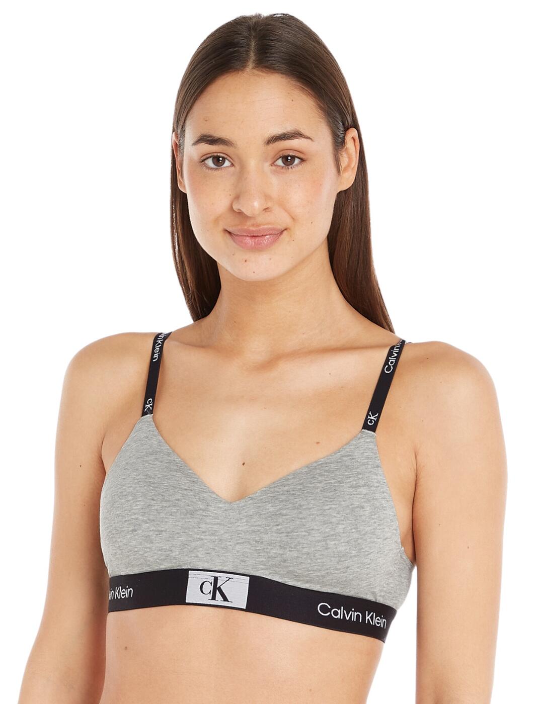 Presenting the Calvin Klein CK1996 lightly lined bralette! For all women out there who are looking for both designer and comfortable lingerie, this is the ideal piece for you. This classic bralette comes in a plain opaque fabric with a minimalist design that is both supportive and flattering. Plus, with the branded elasticated underband, it will provide you with the support and comfort you need. The lightly lined bralette is non-padded and has a wireless design for those looking for effortless ease and comfort. The subtle v-neckline and hook and eye closure provide a sleek and modern look, while the adjustable branded straps allow for an adjustable fit. For a complete designer look, try matching this with the other lingerie pieces also available from Calvin Klein.  Classic bralette Plain opaque minimalist design Supportive branded elasticated underband Lightly lined Non-padded Wireless design Subtle v-neckline Hook and eye closure Branded adjustable straps Matching lingerie is also available Country of origin: Thailand Composition: 69% Cotton &pipe; 21% Recycled Cotton &pipe; 10% Elastane Listed in UK sizes  61538-106636-1413077 000QF7218E Bralette