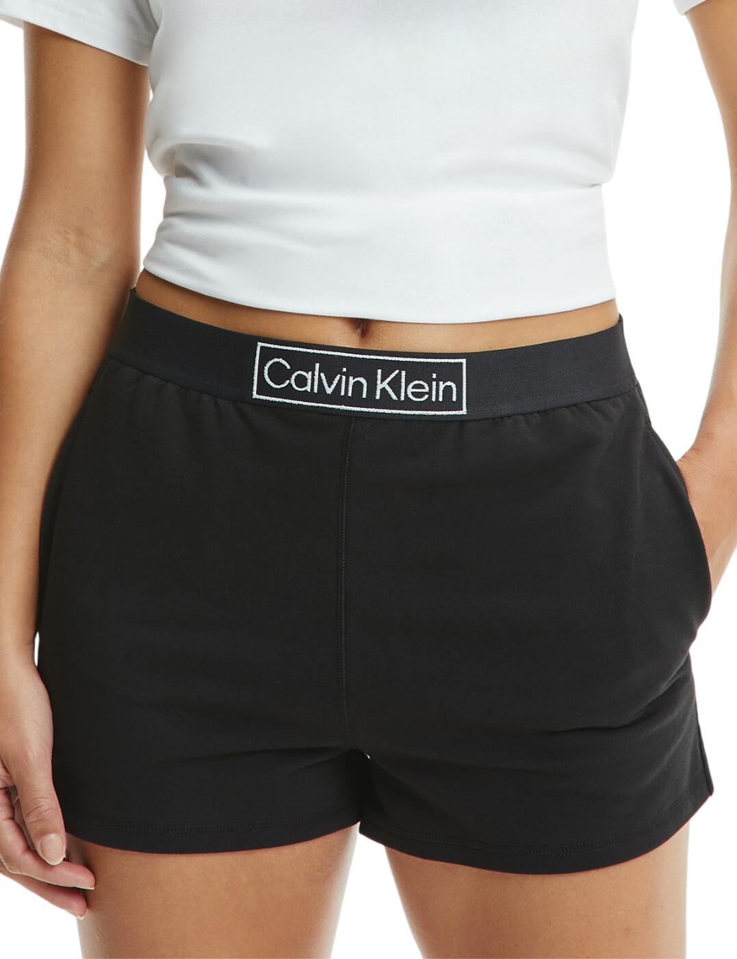 The Reimagined Heritage Loungewear collection by Calvin Klein boasts a collection of sleek and luxuriously comfortable loungewear that you won't want to take off. This sleep short features a wide elasticated waistband that boasts CK signature branding on the front and back. Two side pockets allow you to keep your essentials close by or stash your snacks. The semi-fitted style keeps you looking sleek and polished while you relax. Whether you're lounging, sleeping or exercising these shorts are a must-have for any CK fan. Pair with matching tops and tees from the collection for a coordinated look.  Matching items available Comfortable and sleek CK branding Two side pockets Country of origin: 70% Organic Cotton &pipe; 20% Recycled Cotton &pipe; 10% Elastane Listed in UK sizes  54319-97047 000QS6799E Lounge Short